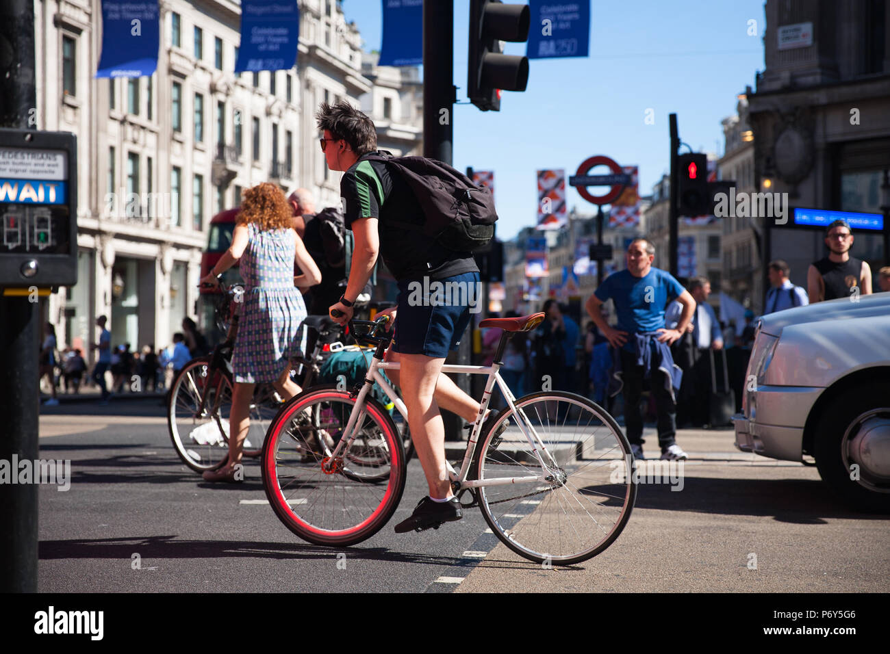 Cyclist in busy high street hi-res stock photography and images - Alamy