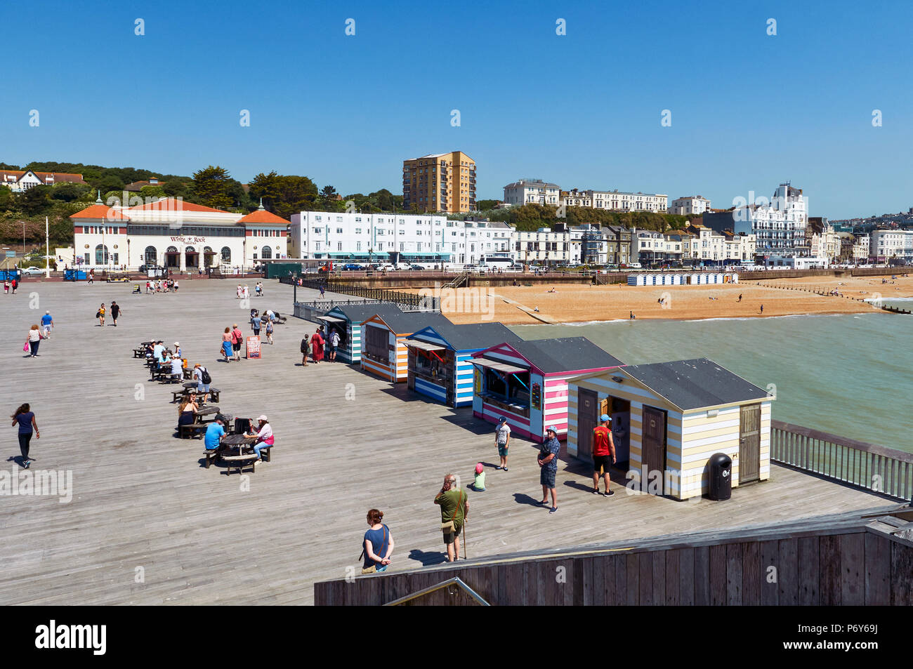 Hastings UK pier deck and Hastings seafront in summer, looking East