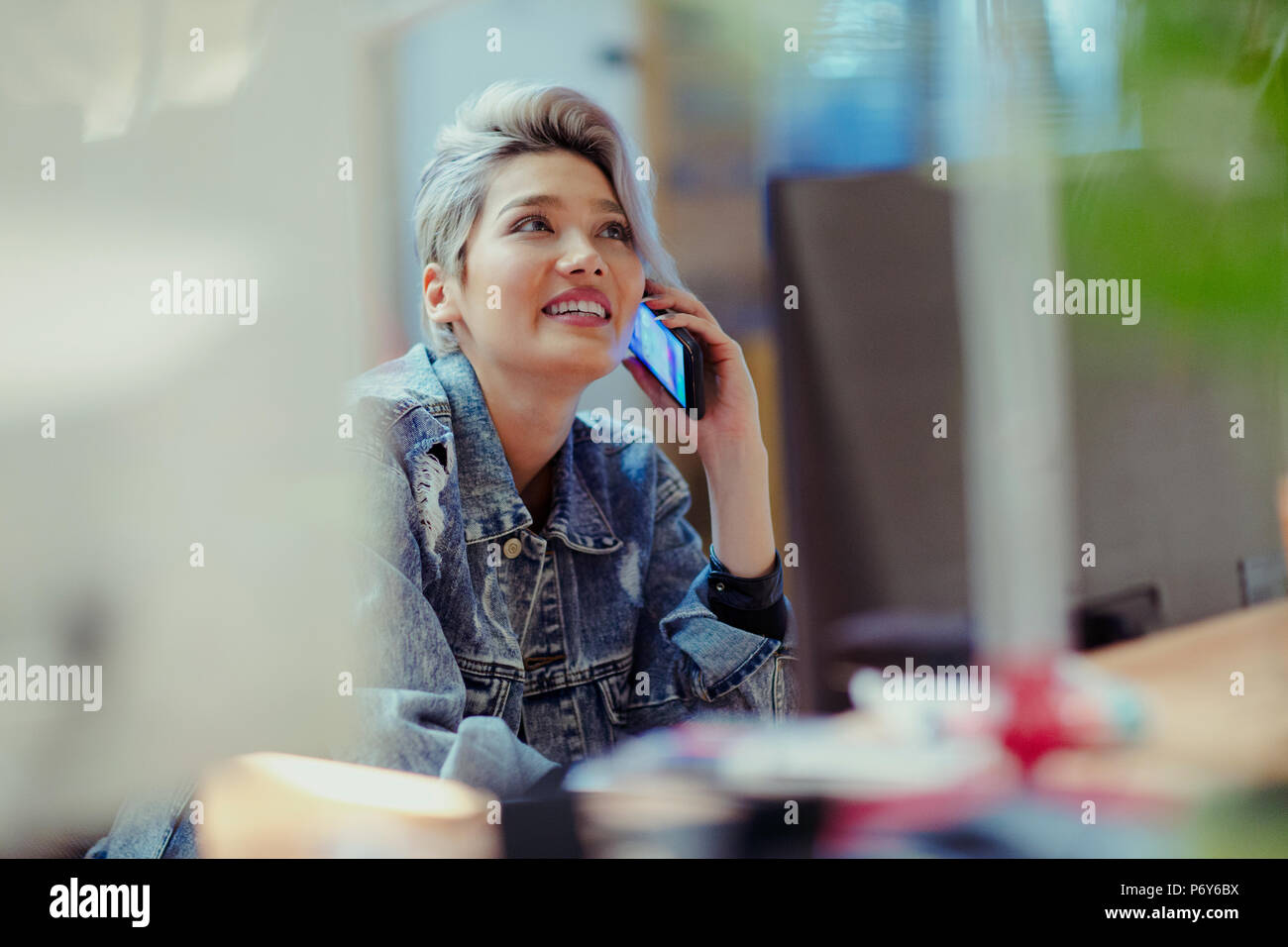 Creative businesswoman talking on smart phone Stock Photo