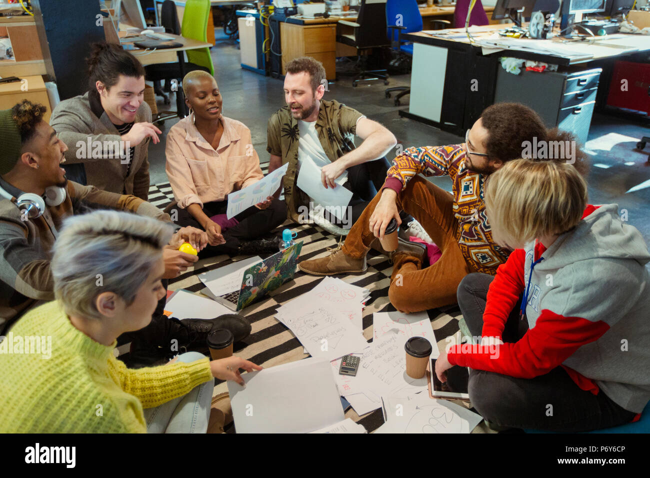 Creative business team meeting, brainstorming circle on office floor Stock Photo