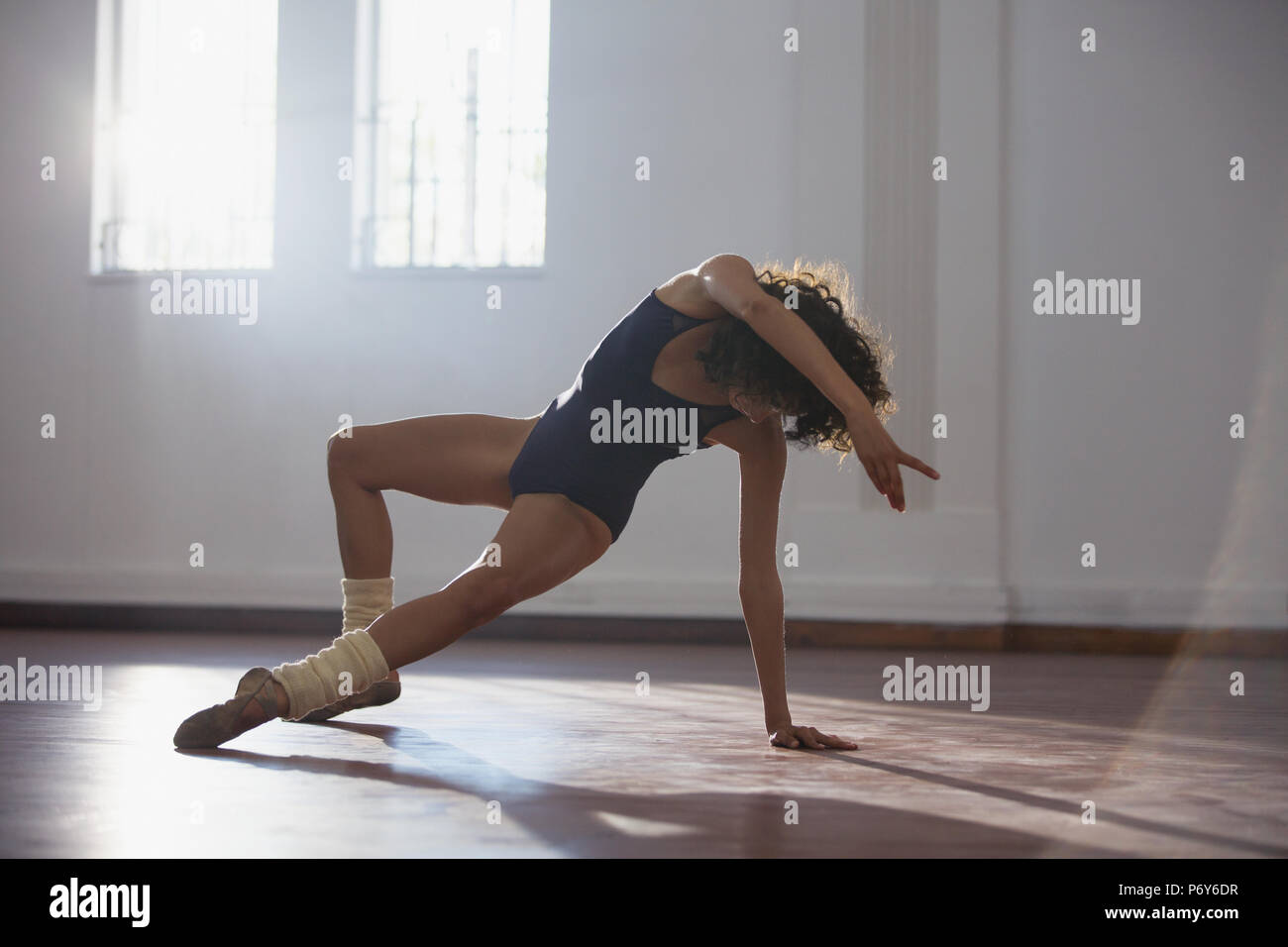 Graceful young female dancer practicing in dance studio Stock Photo