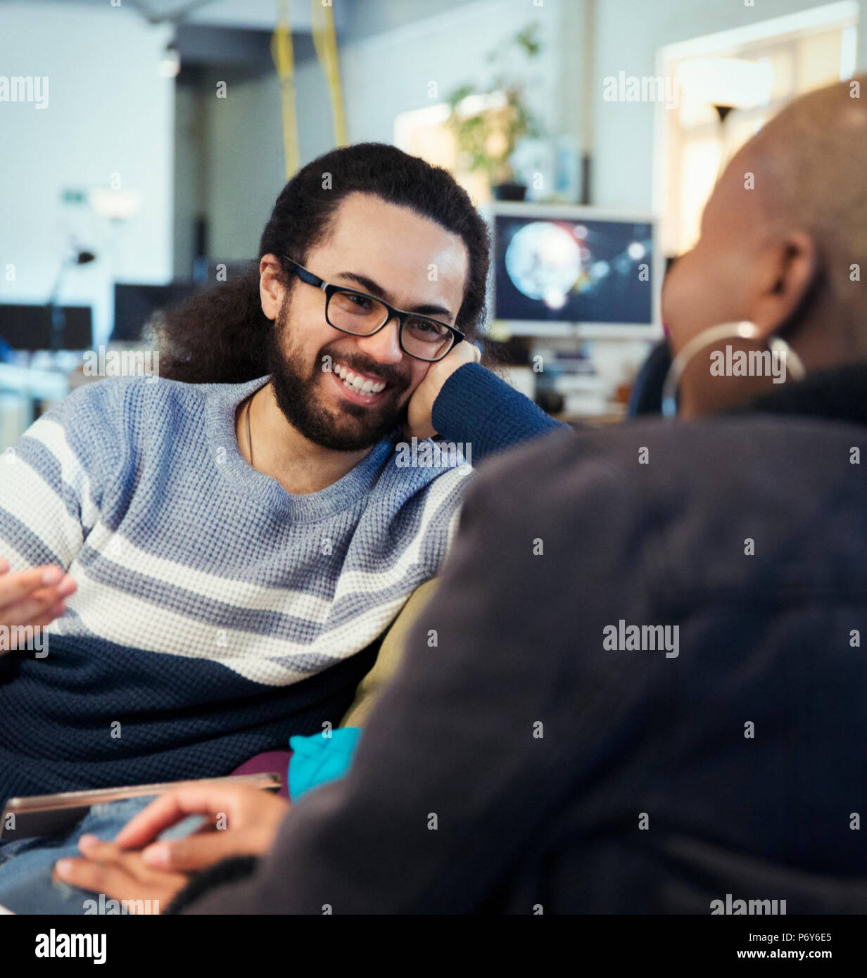 Smiling creative business people talking in office Stock Photo