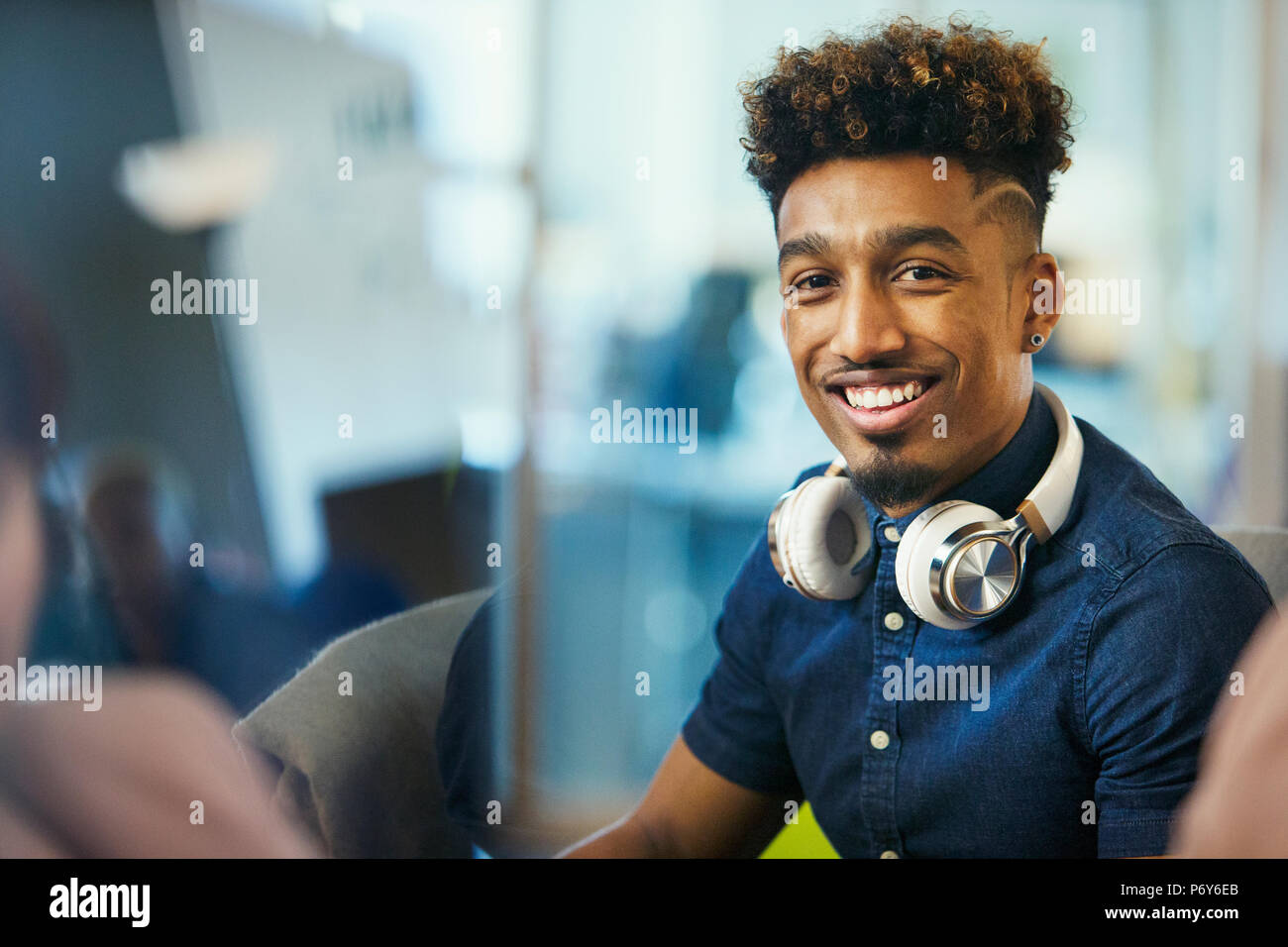 Portrait smiling, confident creative businessman with headphones Stock Photo