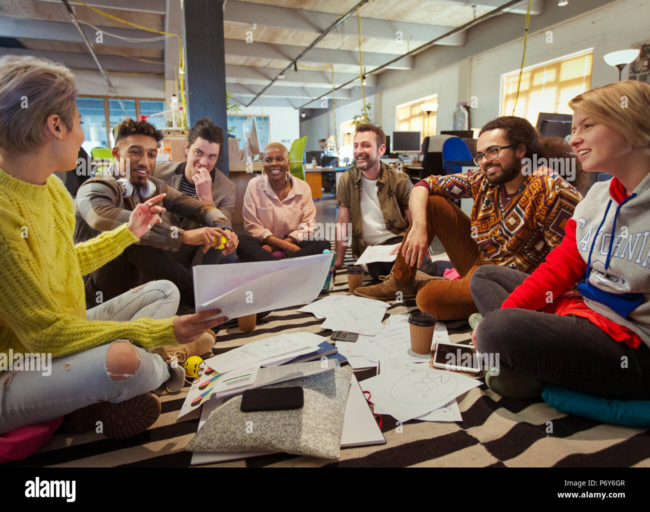 Creative business team meeting, brainstorming in circle on floor Stock Photo