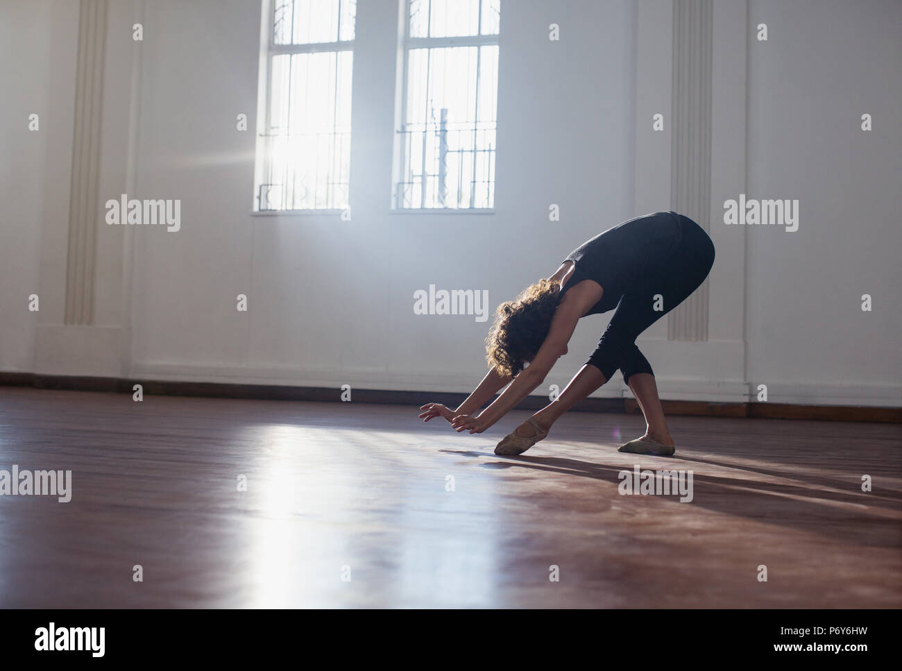 Graceful young female dancer practicing in dance studio Stock Photo