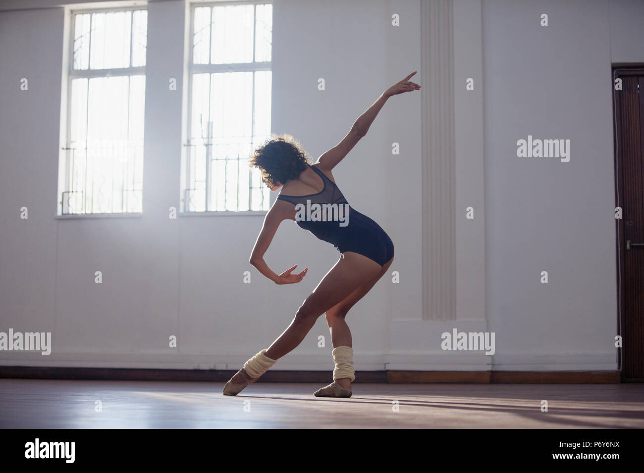 Graceful young female dancer practicing in dance studio Stock Photo