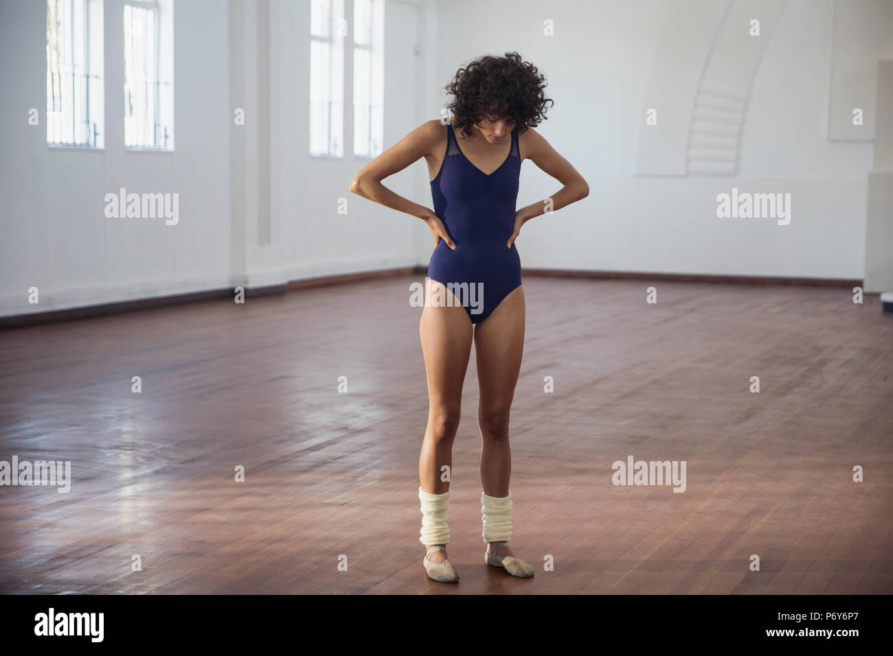 Dedicated young female dancer practicing in dance studio Stock Photo
