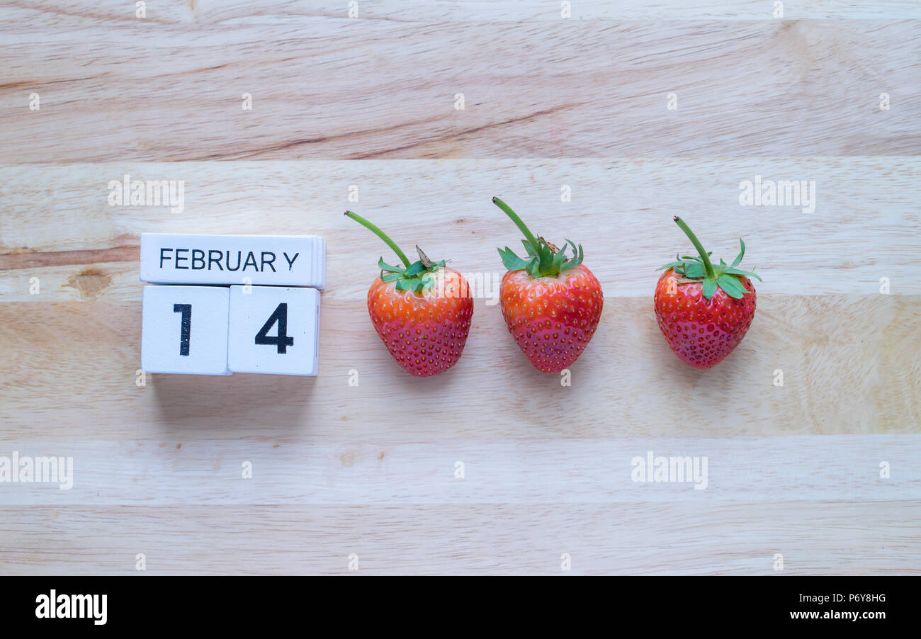 Alphabet 14 February and strawberrys on wooden background, Stock Photo