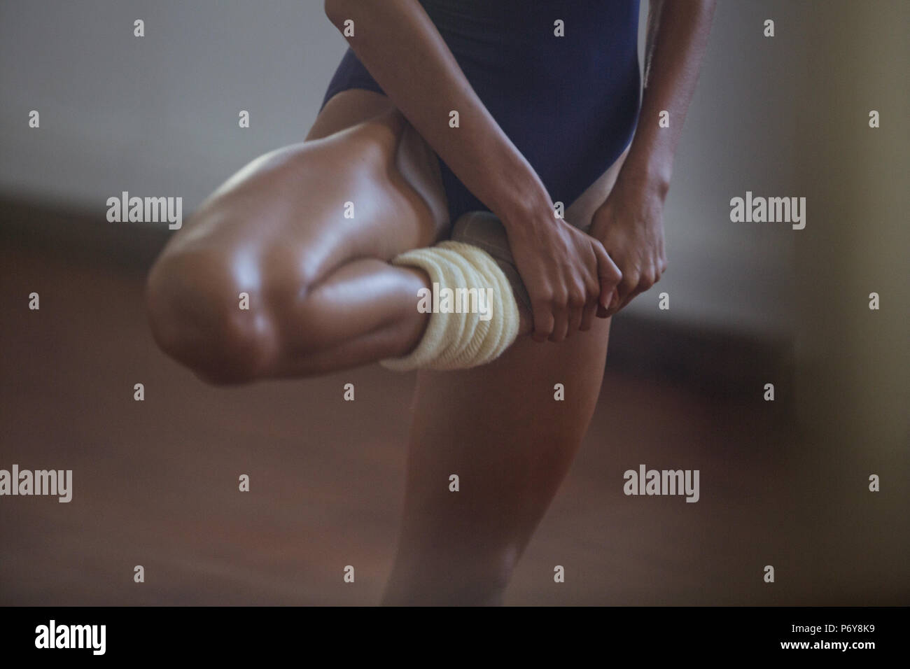 Strong, young female dancer stretching leg Stock Photo