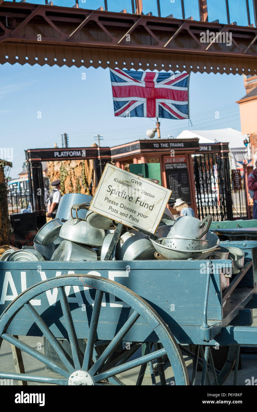 Severn Valley Railway 1940's summer event, Kidderminster. Community spirit: pots & pans in cart for nation's Spitfire Fund, supporting war efforts. Stock Photo
