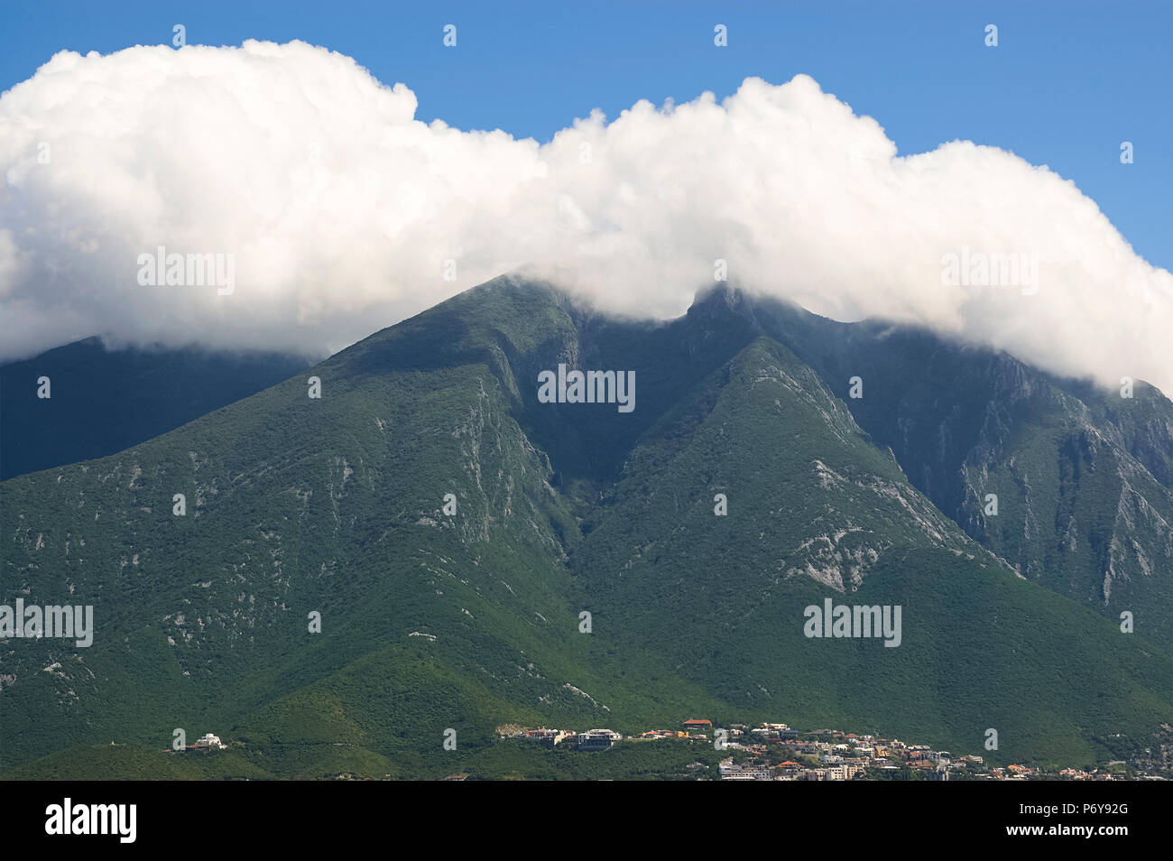 La Silla Hill, named this way because it resembles a saddle, covered in clouds. The hill is a landmark for the city of Monterrey, Nuevo Leon, Mexico. Stock Photo