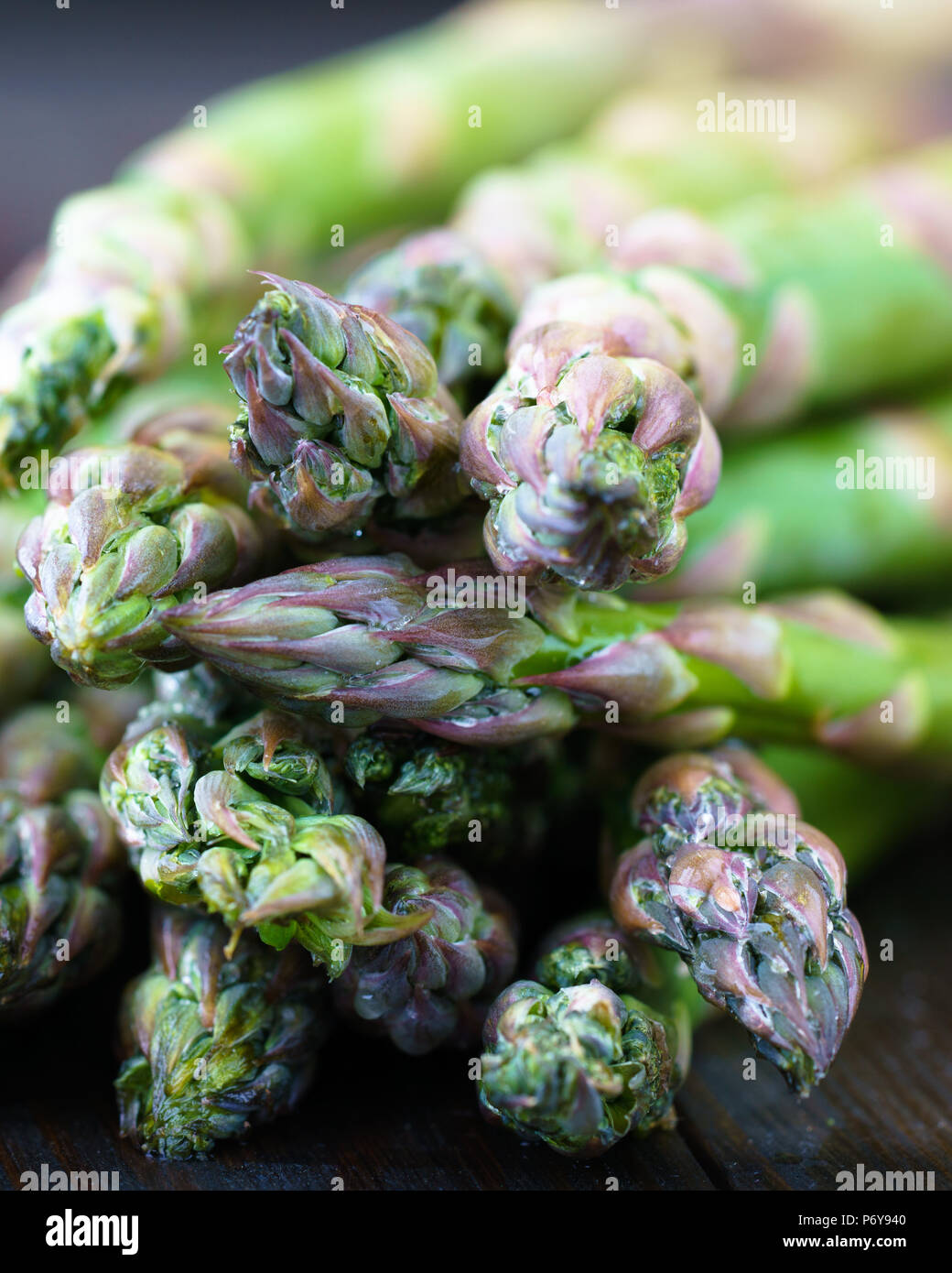 Macro shot of fresh asparagus on a dark wooden background. High resolution Stock Photo