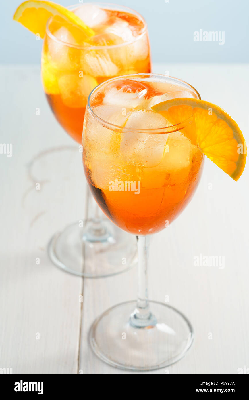 Aperol Spritz served with an orange slice in wine glasses. White ...