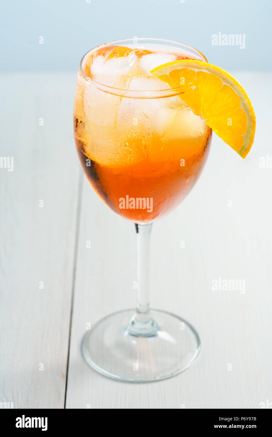 Aperol Spritz served with an orange slice in wine glass. White ...