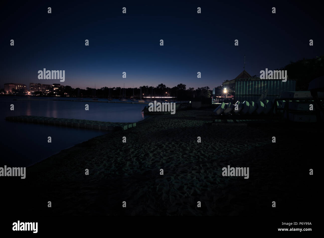 Long exposure of a city lake just after sunset. Stock Photo