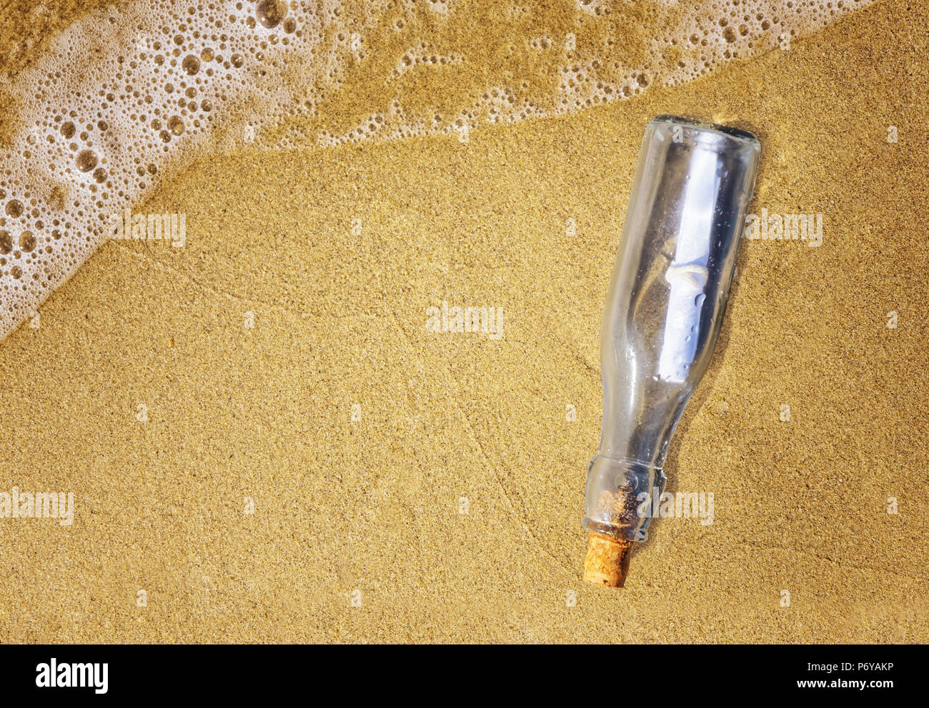 Message in a bottle on the shore top view Stock Photo