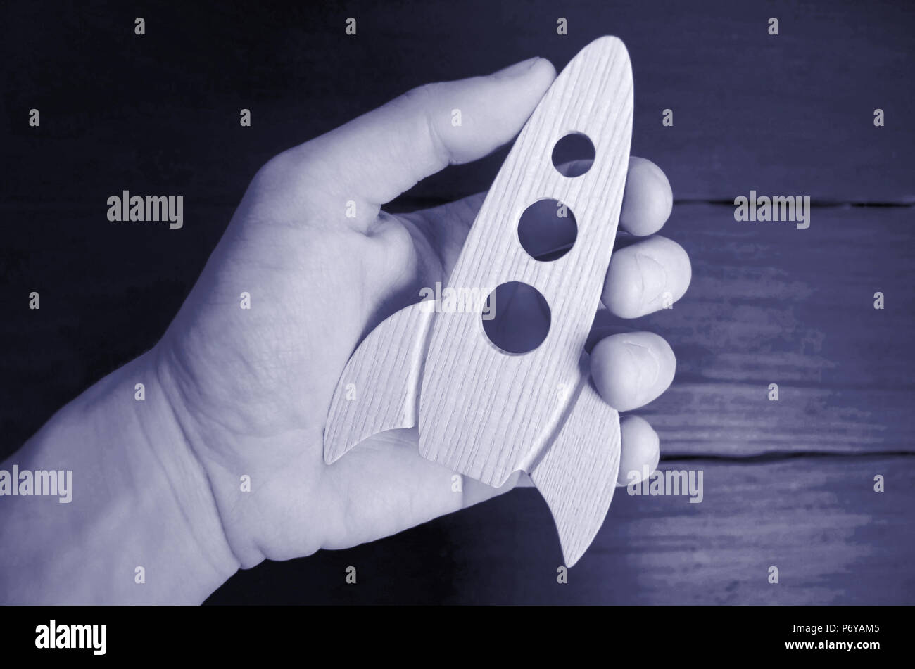 Rocket Hand Work Rocket in hand concept. The hand holds a wooden rocket. The rocket is ...