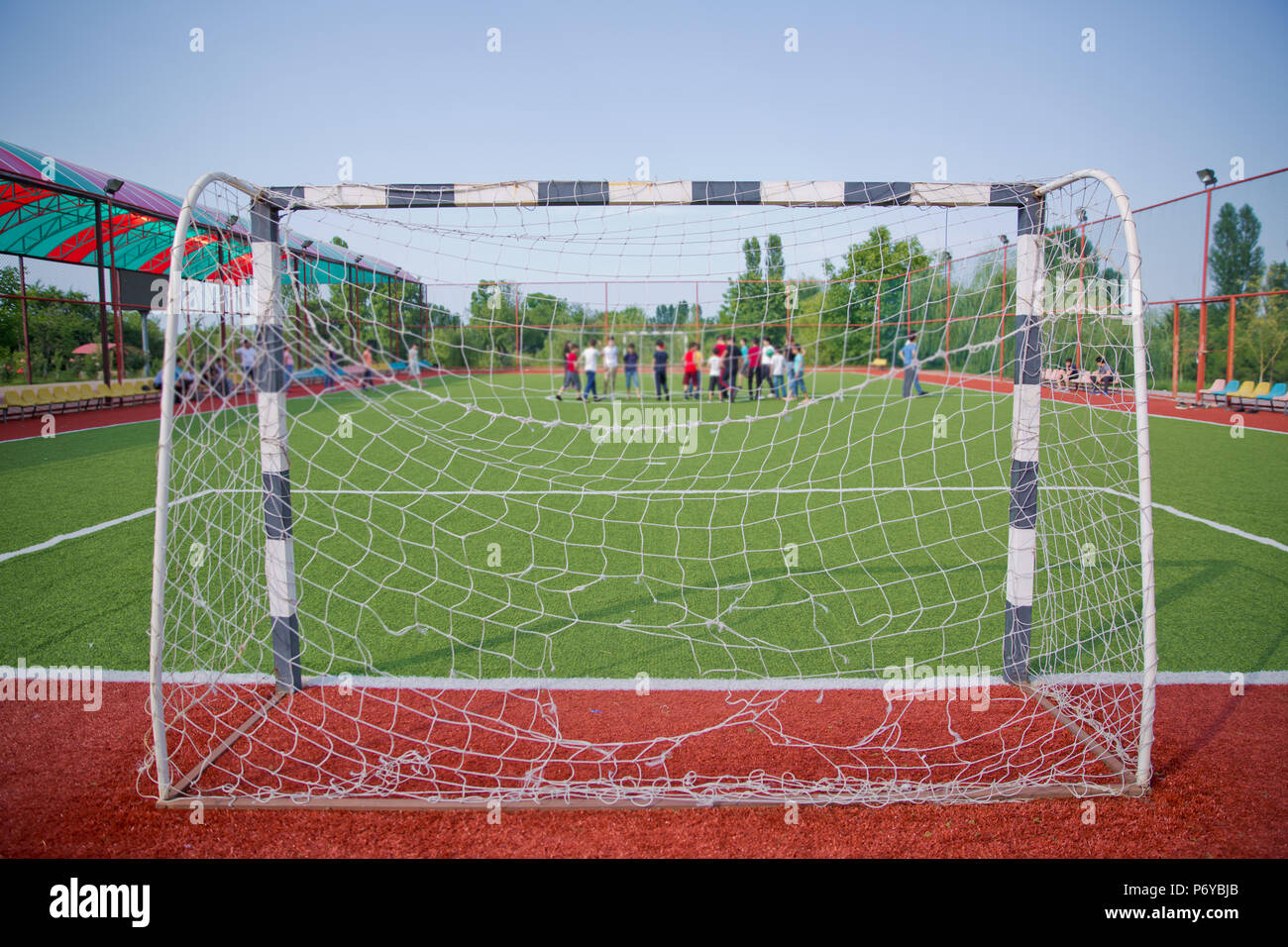 Mini Football Goal On An Artificial Grass . Football defocused players penalty on field Small, Futsal ball field in the gym indoor, Soccer sport field . Corner of a soccer field Stock Photo