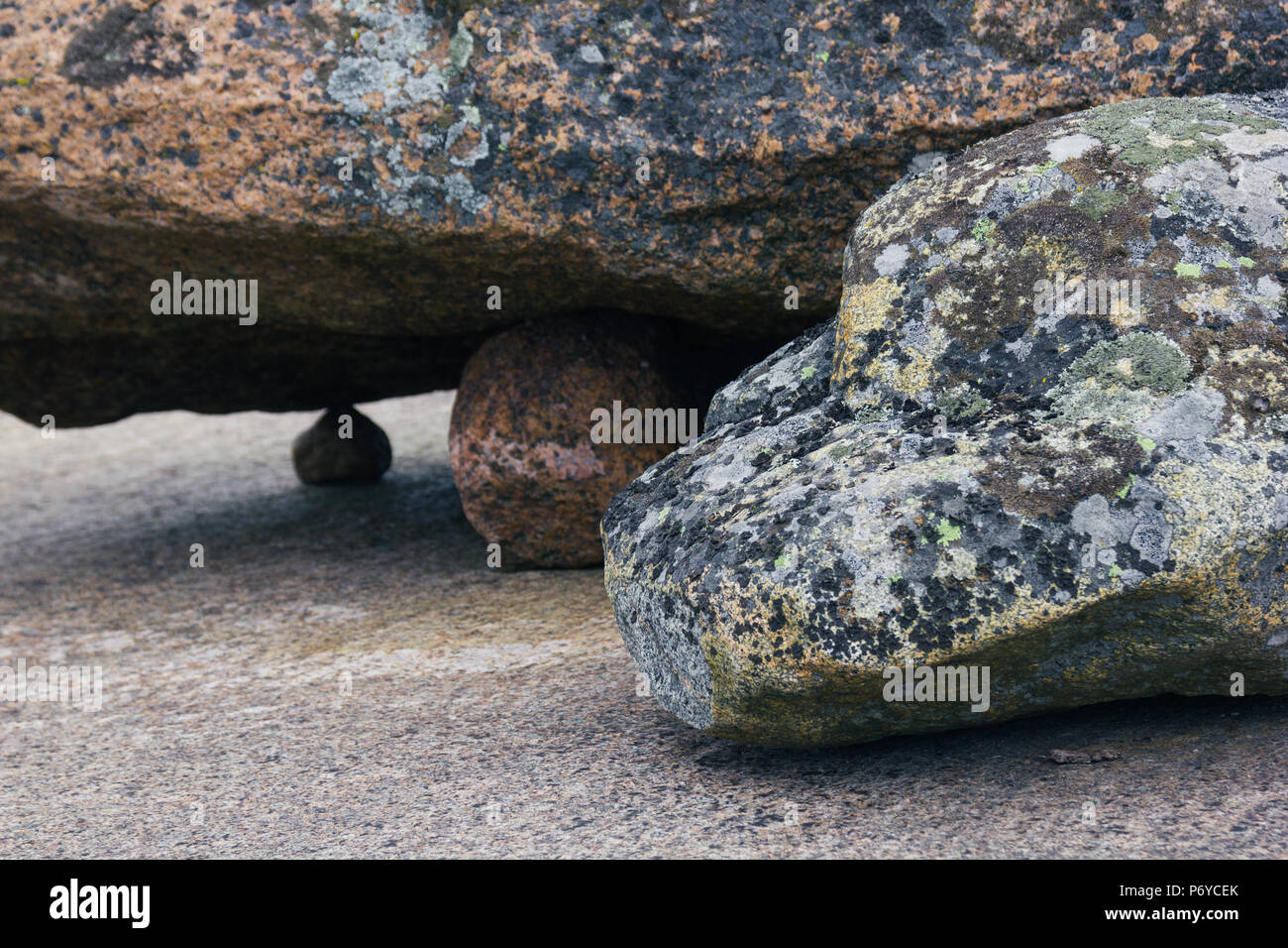 Four boulders, large boulder resting on smaller ones Stock Photo