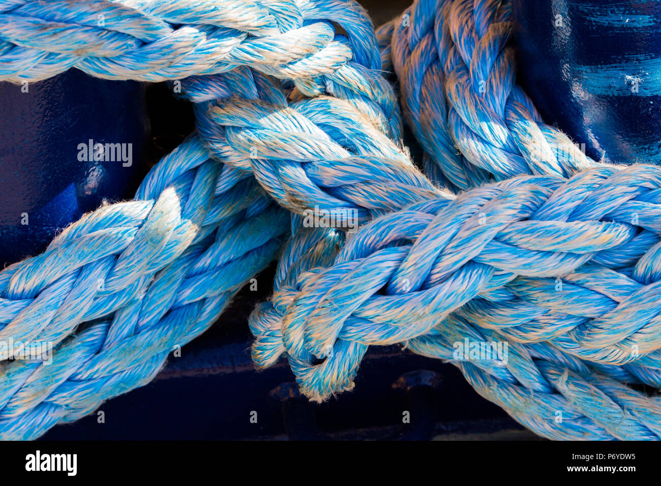 Close-up of blue thick weathered nylon ropes Stock Photo