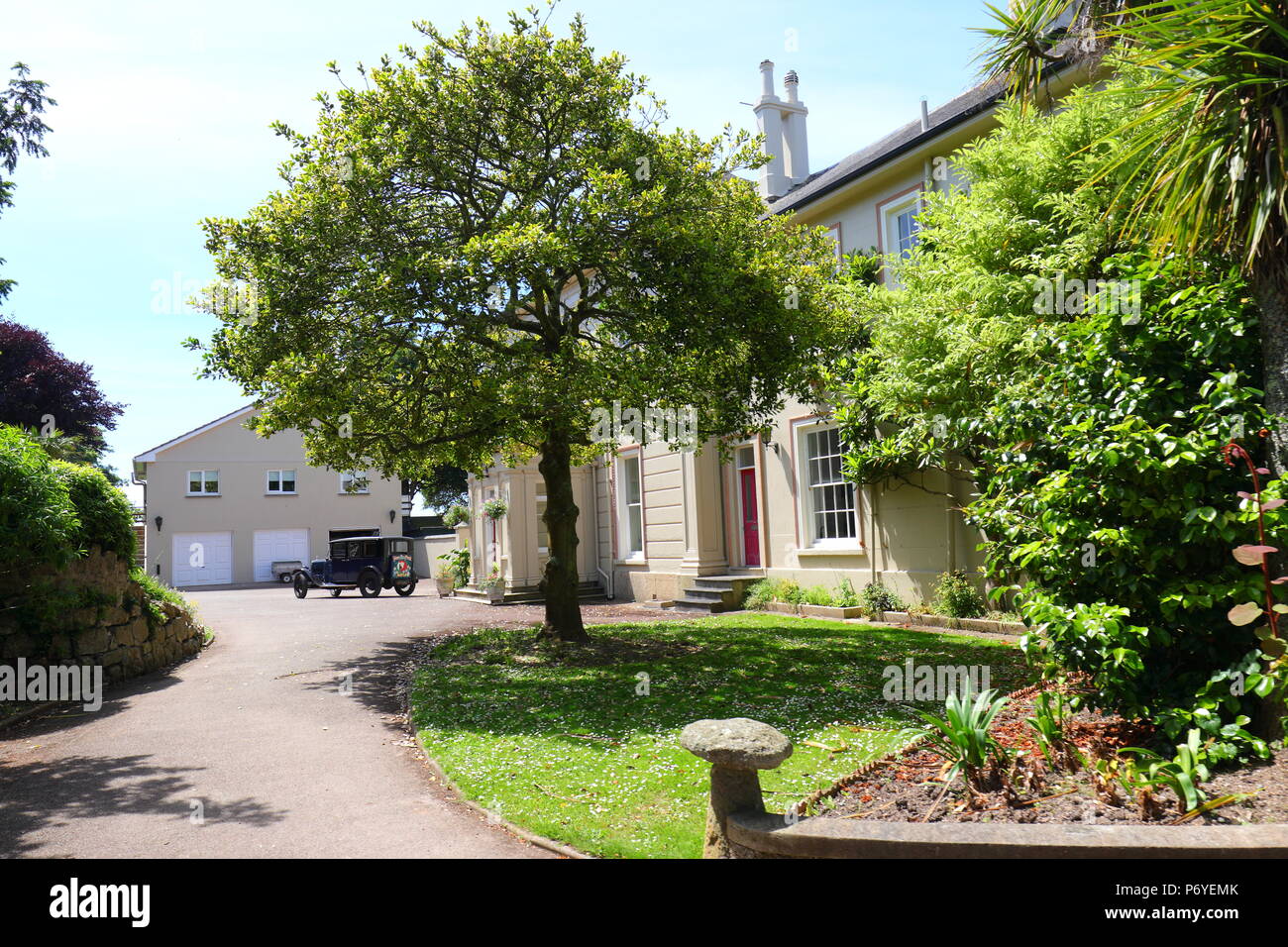 A Vintage Austin motor car used for advertising,sits on a driveway in