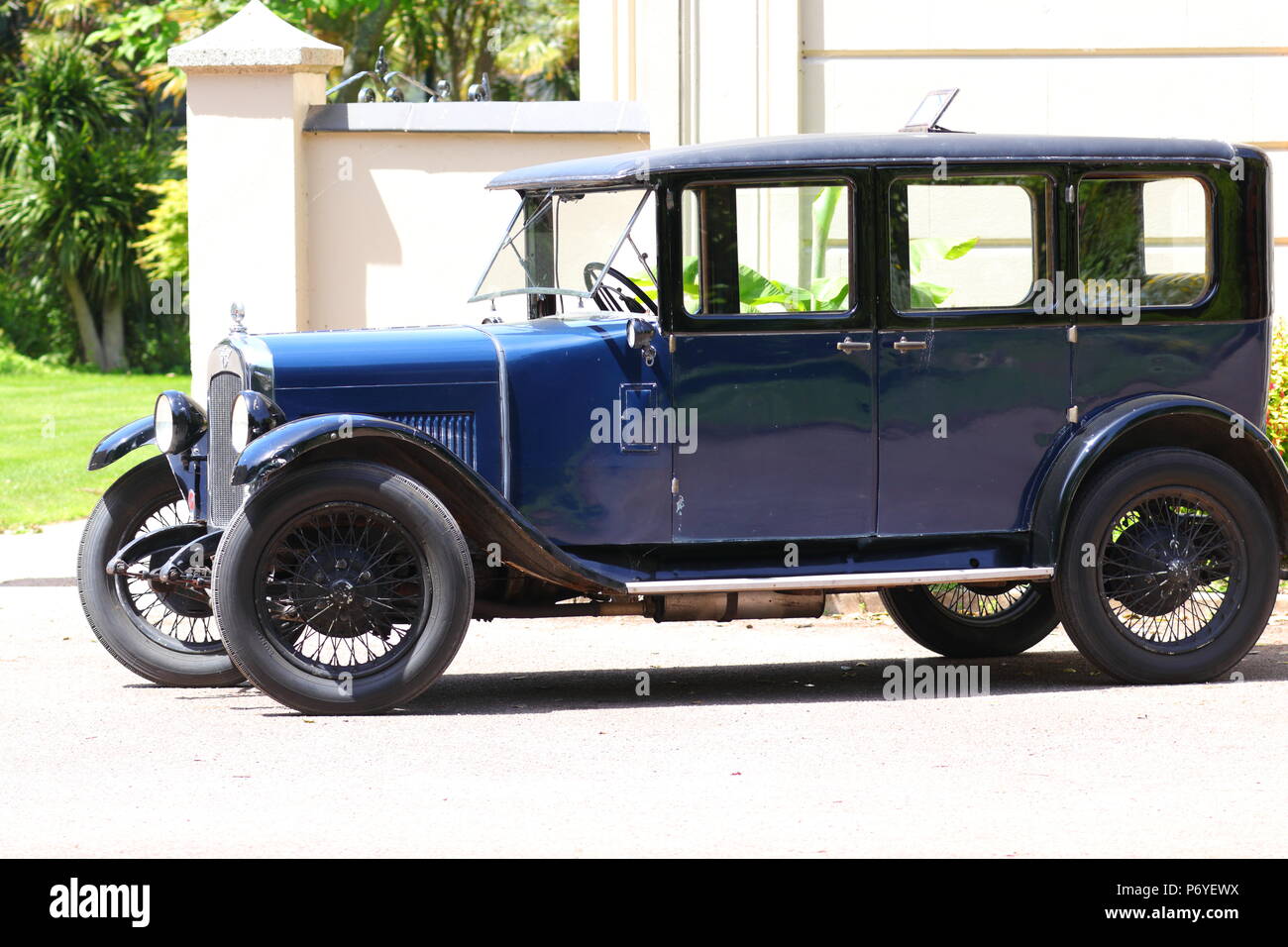 A Vintage Austin motor car used for advertising,sits on a driveway in
