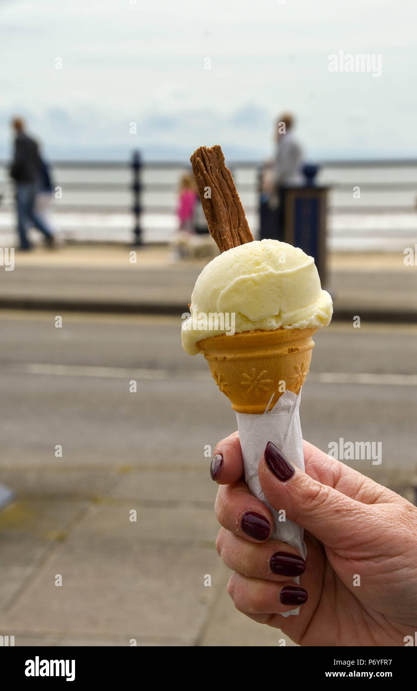 Close up view of a vanilla ice cream cone with a chocolate insert Stock Photo
