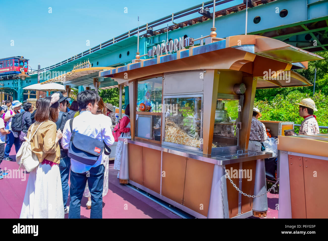 Tourists buying popcorn from a popcorn wagon in Tokyo Disneysea Stock Photo