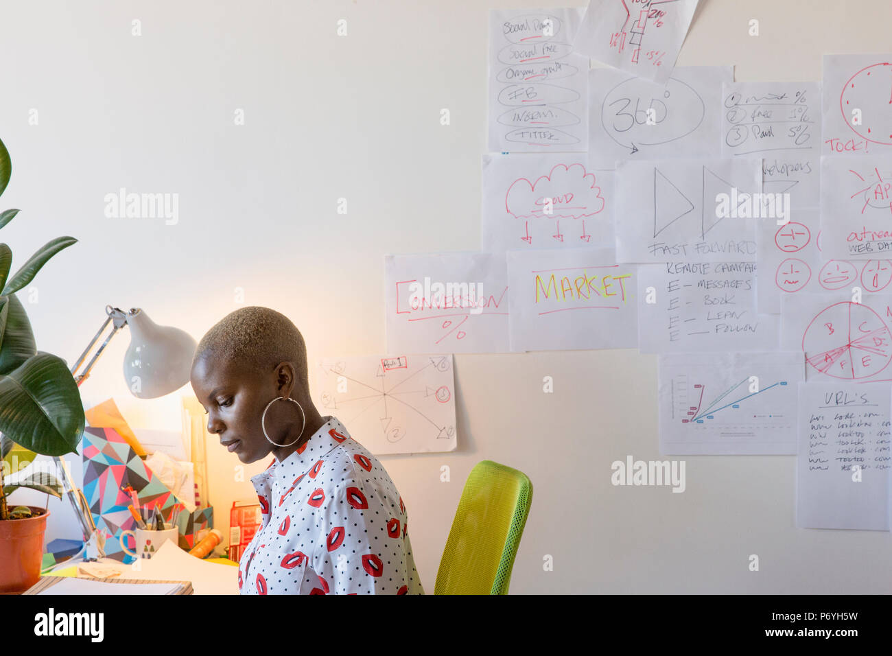 Creative businesswoman working at desk in office Stock Photo