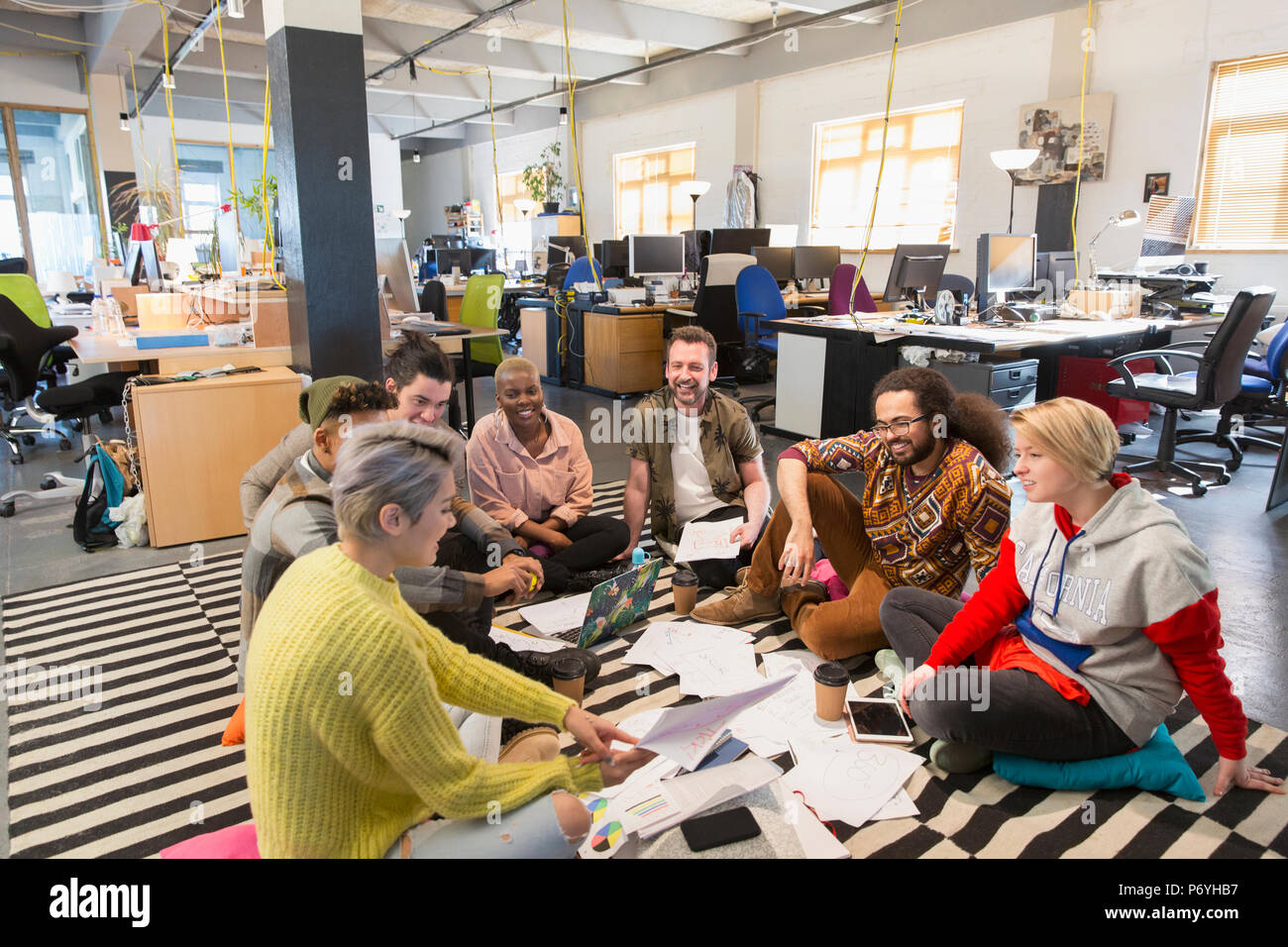 Creative business team meeting, brainstorming on floor in office Stock Photo