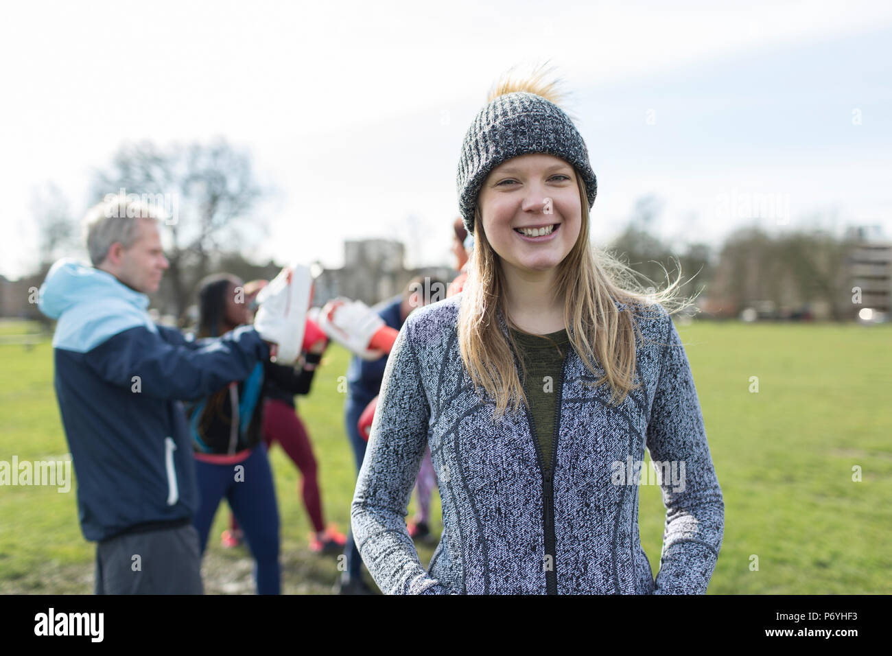 Smiling woman standing in park hi-res stock photography and images - Alamy