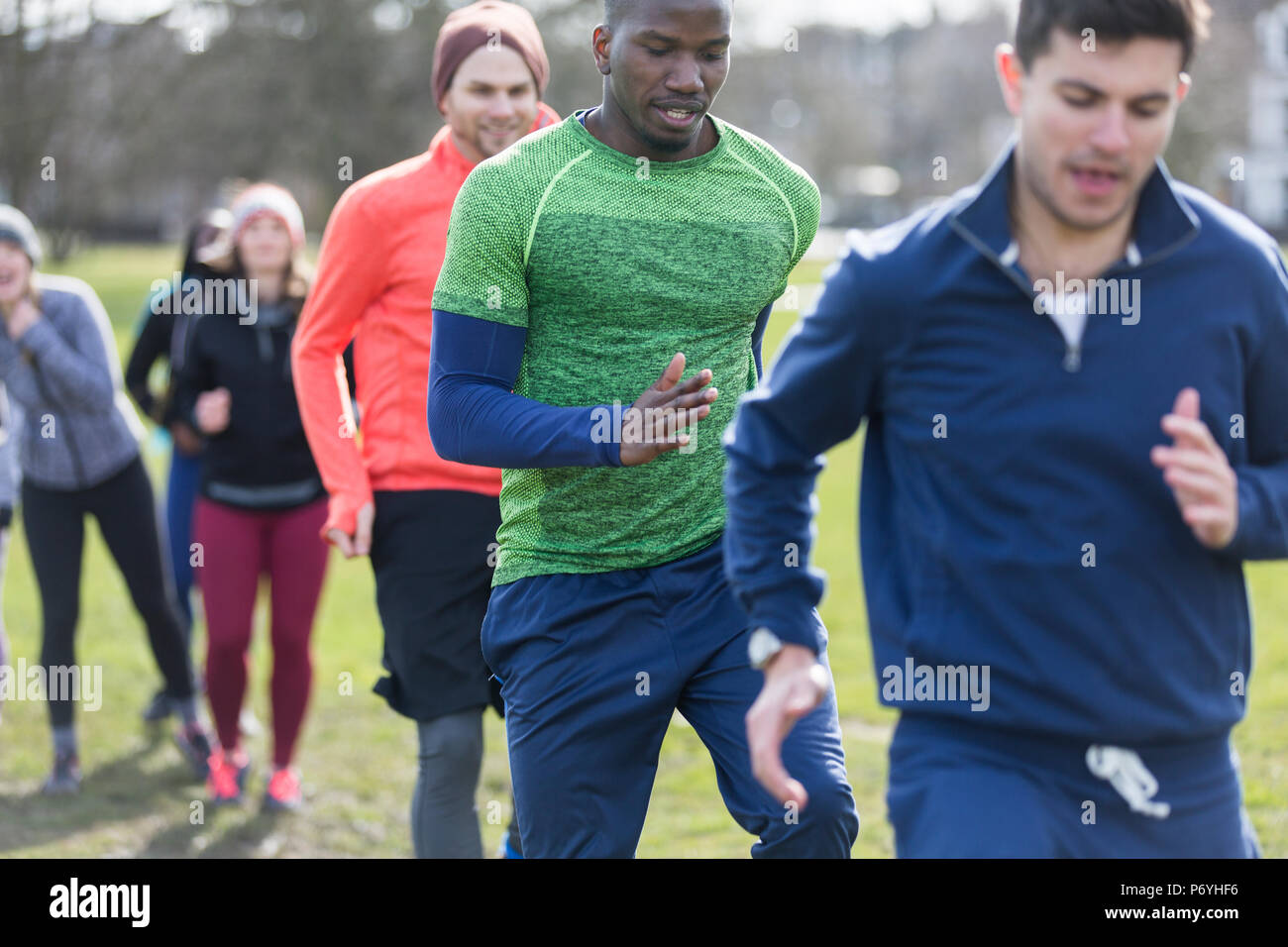 Focused men exercising, doing drill in park Stock Photo
