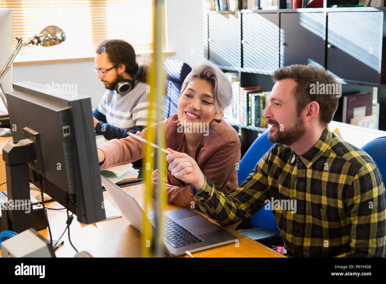 Creative business people meeting, working at computer in office Stock Photo