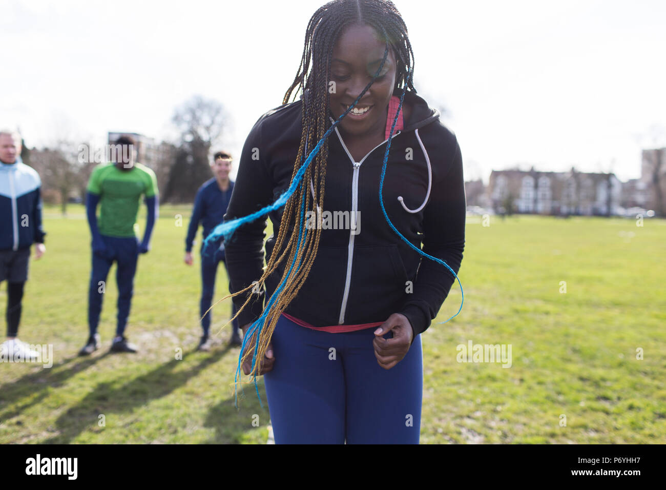 Smiling woman exercising in park Stock Photo