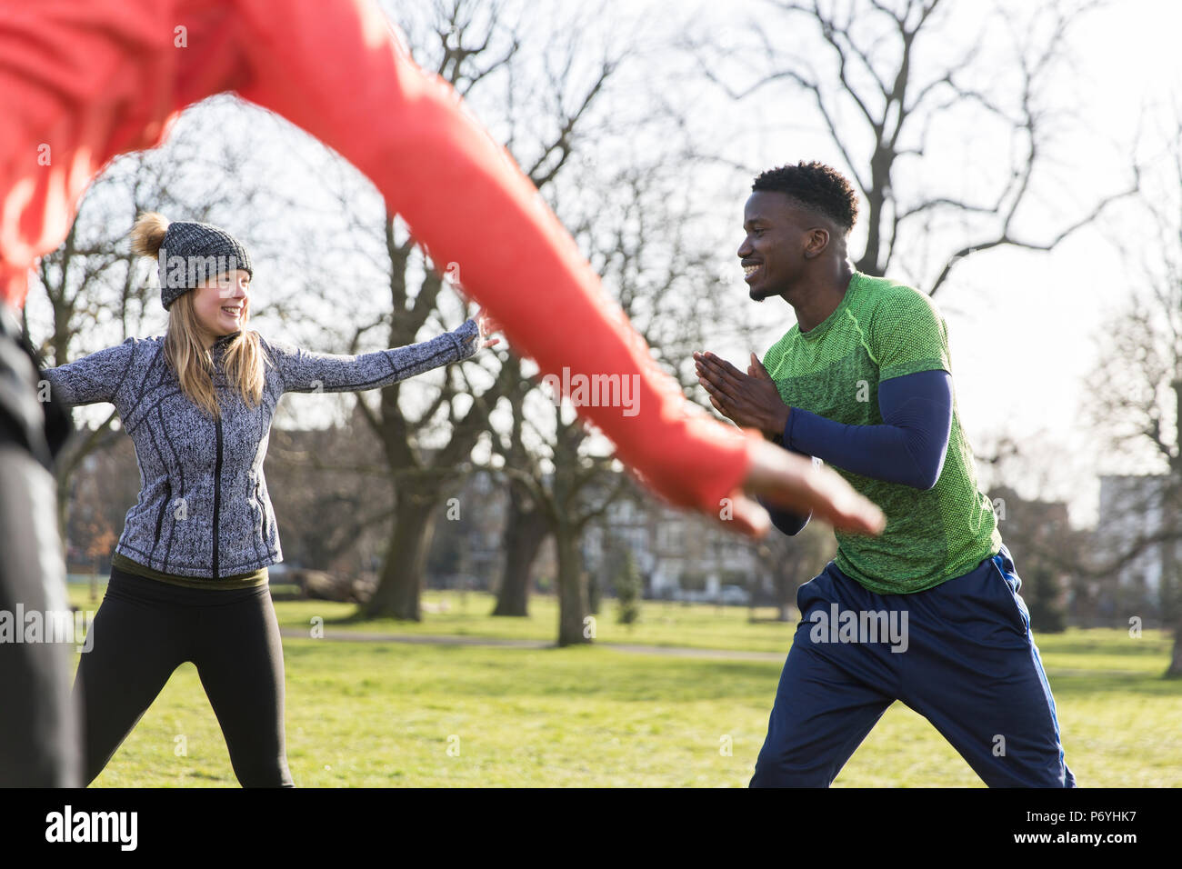 People exercising, stretching in park Stock Photo
