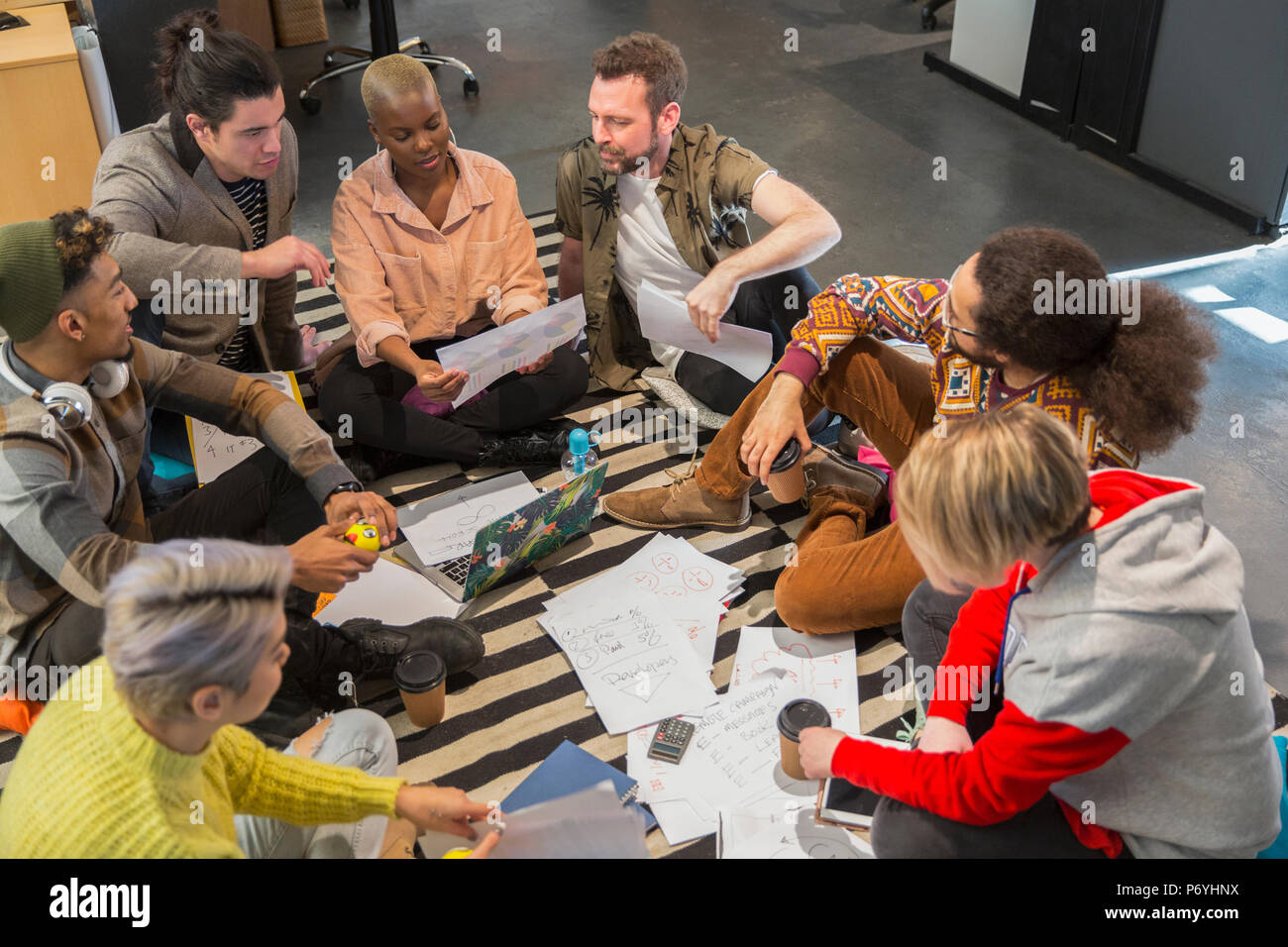 Creative business people meeting, brainstorming in circle on floor Stock Photo
