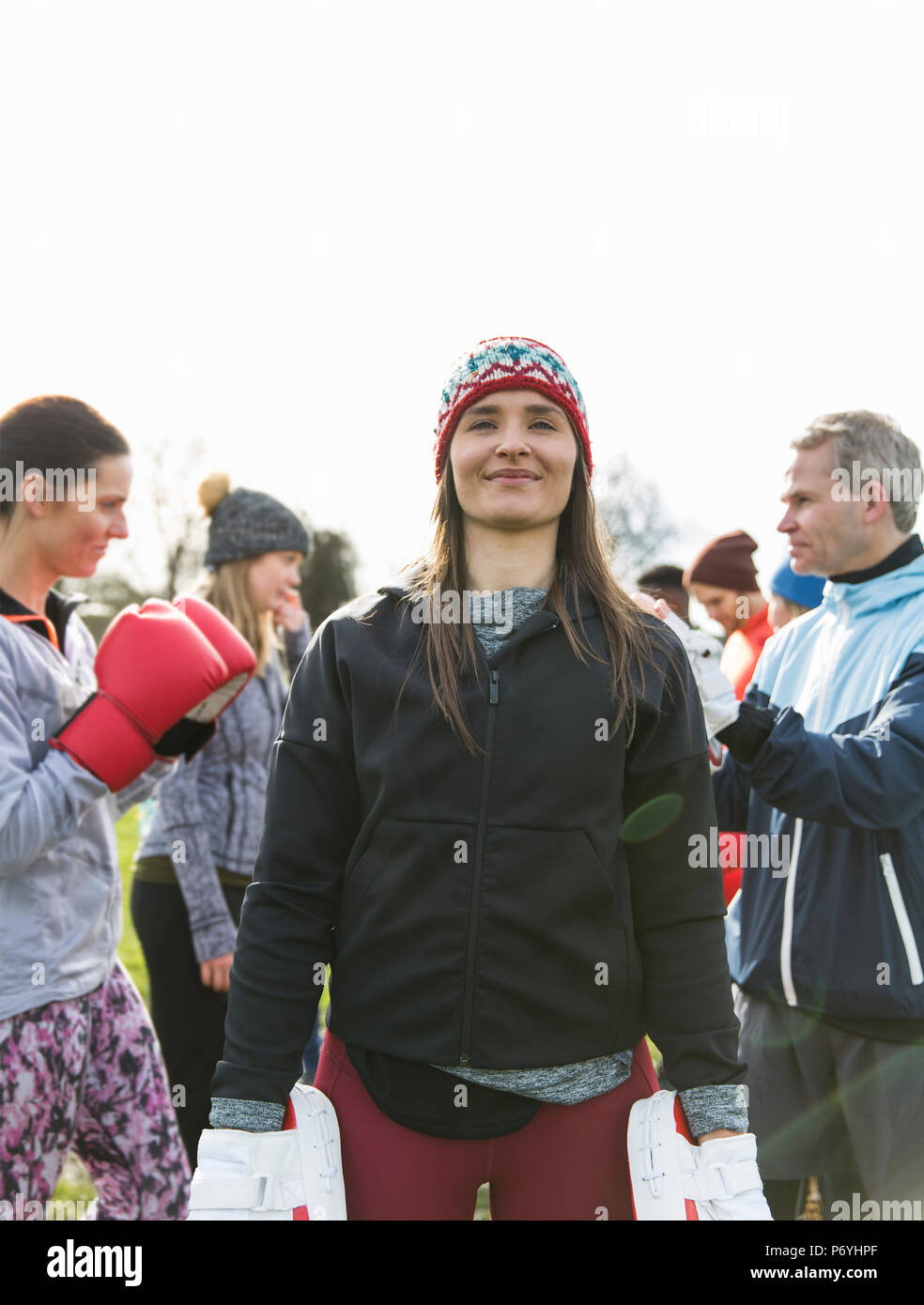 Portrait confident woman boxing in park Stock Photo
