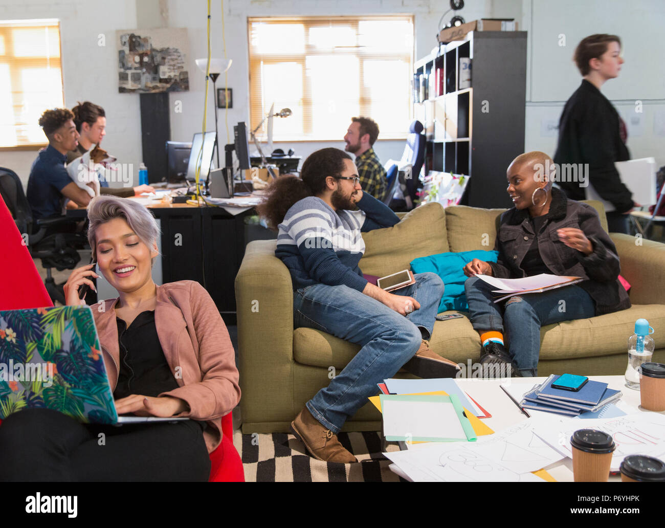 Creative business people meeting and working in casual, open plan office Stock Photo