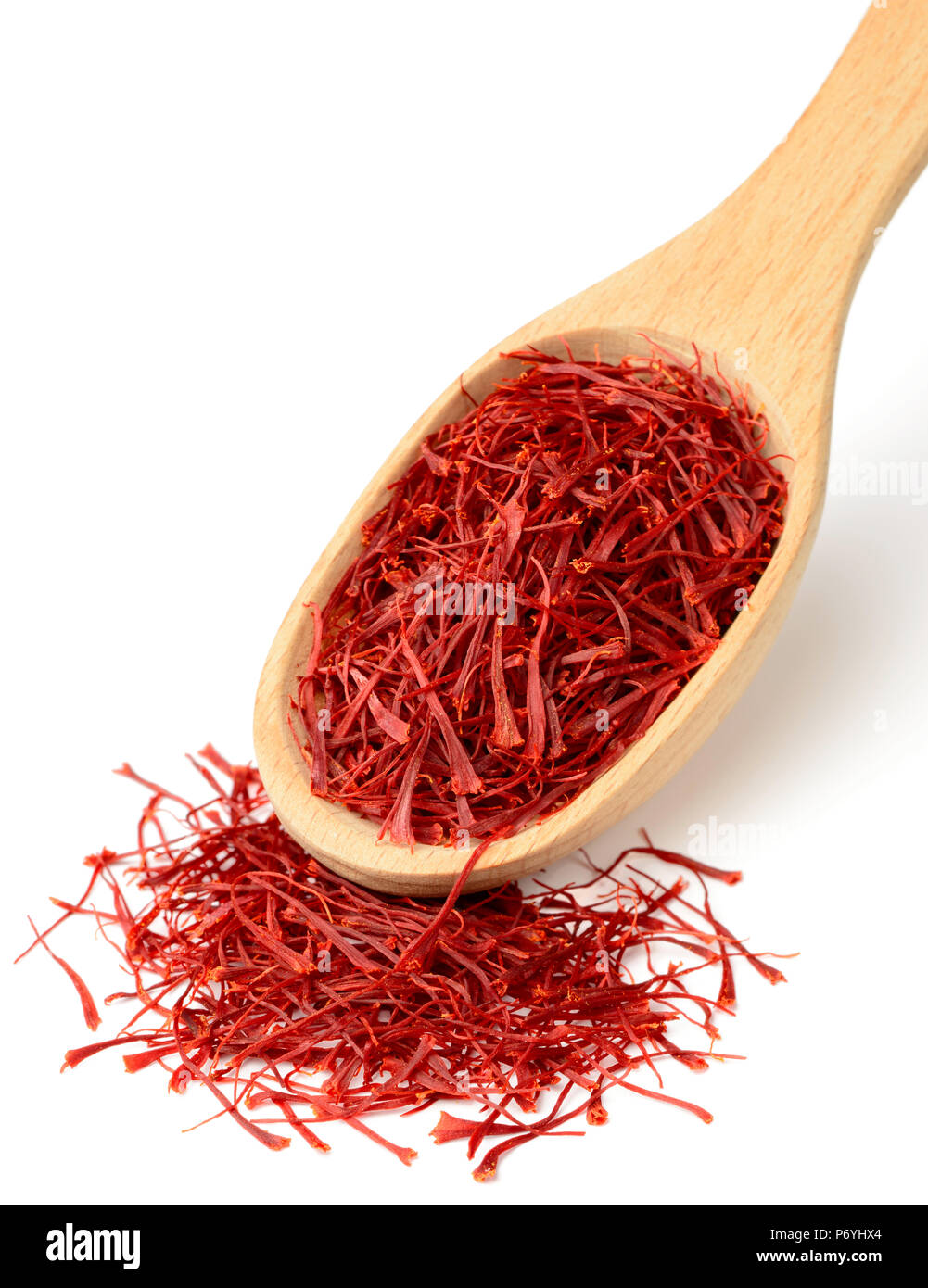 saffron thread in the wooden spoon, isolated on white background Stock Photo