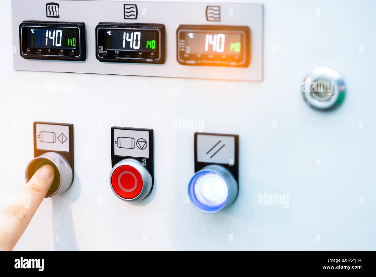 Engineer's hand push green button to open temperature control machine