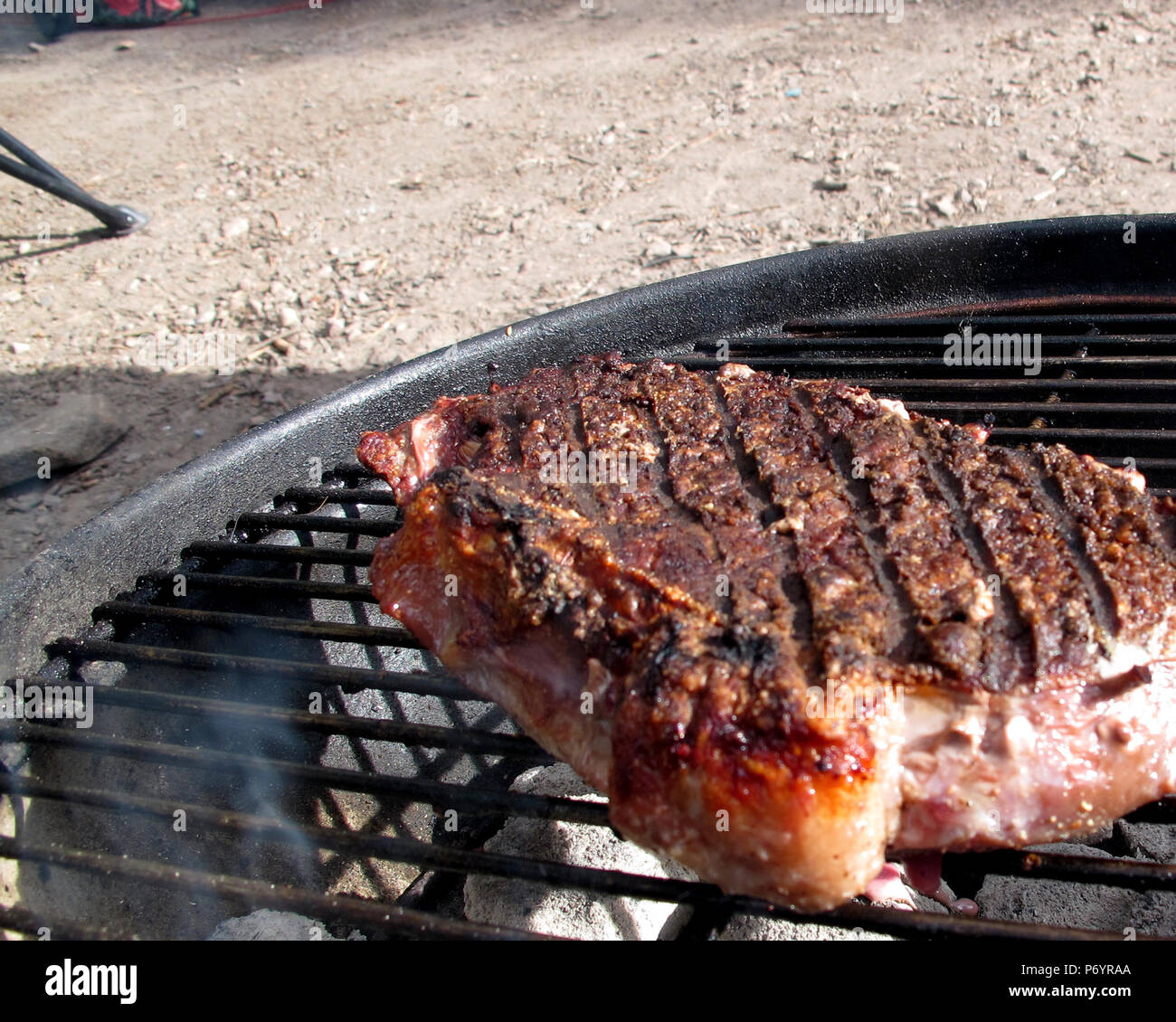 New York Steak Cooking Outdoors on Charcoal Grill Stock Photo Alamy