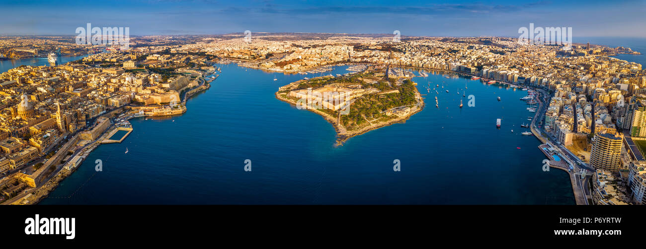 Valletta, Malta - Aerial panoramic skyline view of Valletta, Sliema, Manoel Island, Gzira, Ta' Xbiex, Msida and Floriana at sunrise Stock Photo