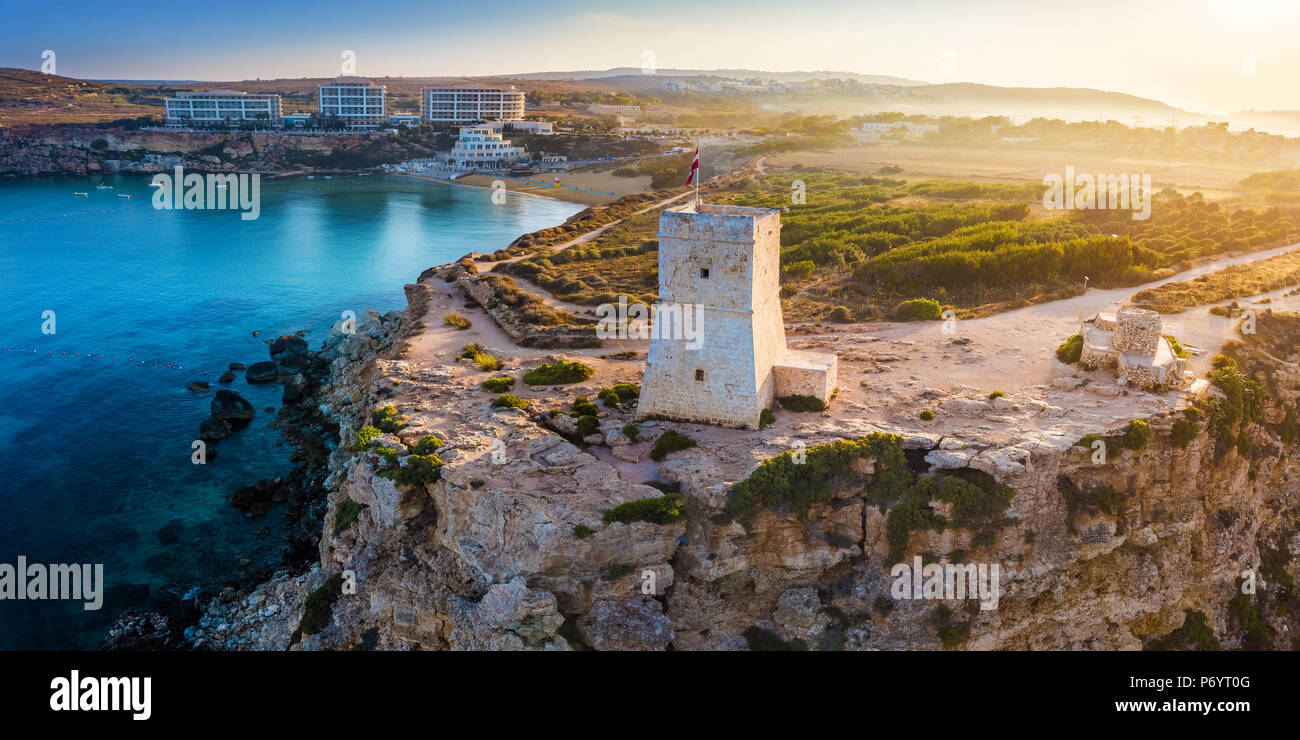 Ghajn Tuffieha, Malta - Beautiful sunrise at Ghajn Tuffieha Watch Tower with Golden Bay beach at background Stock Photo