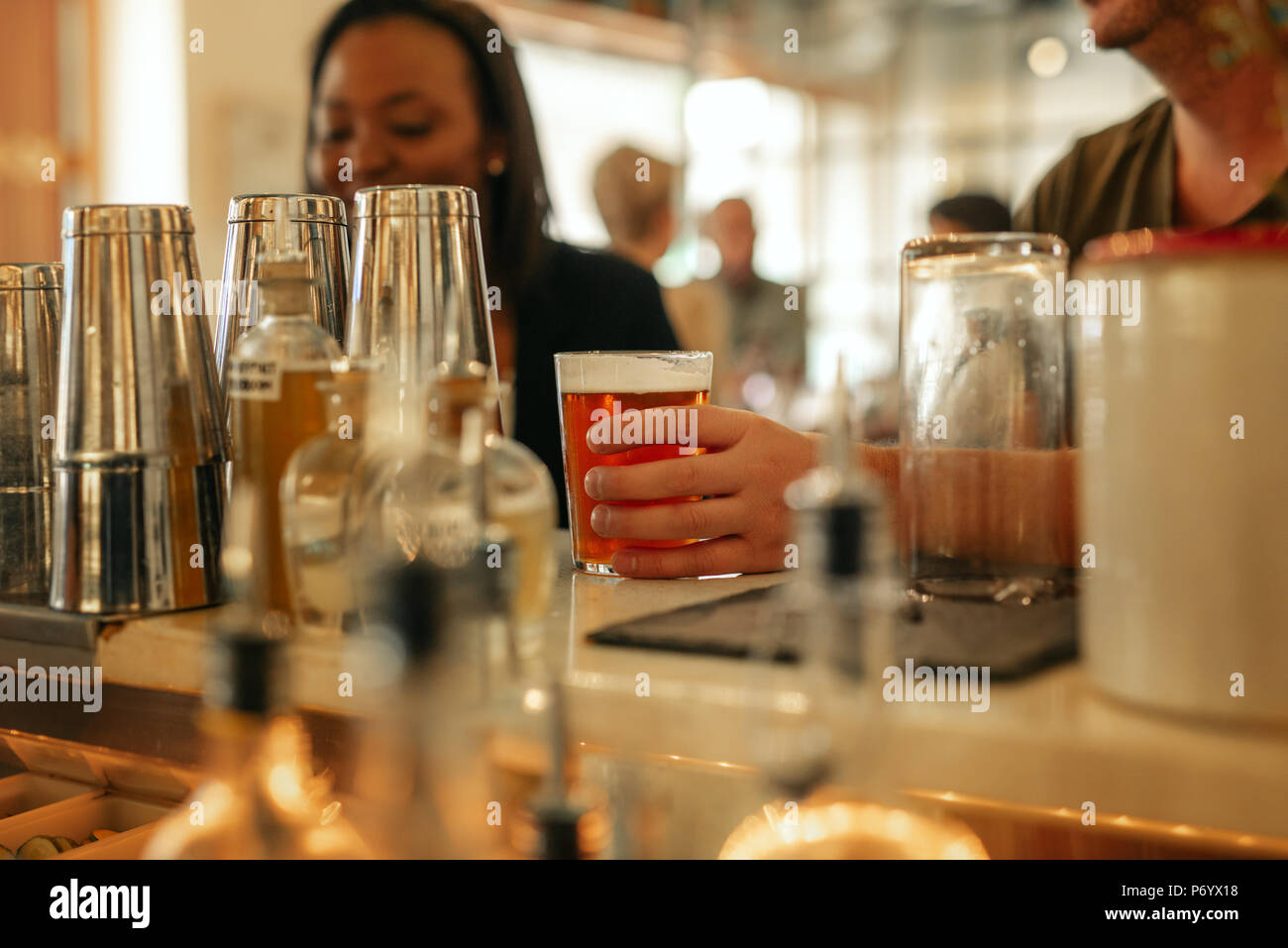 Friends having drinks together at the counter of a bar Stock Photo