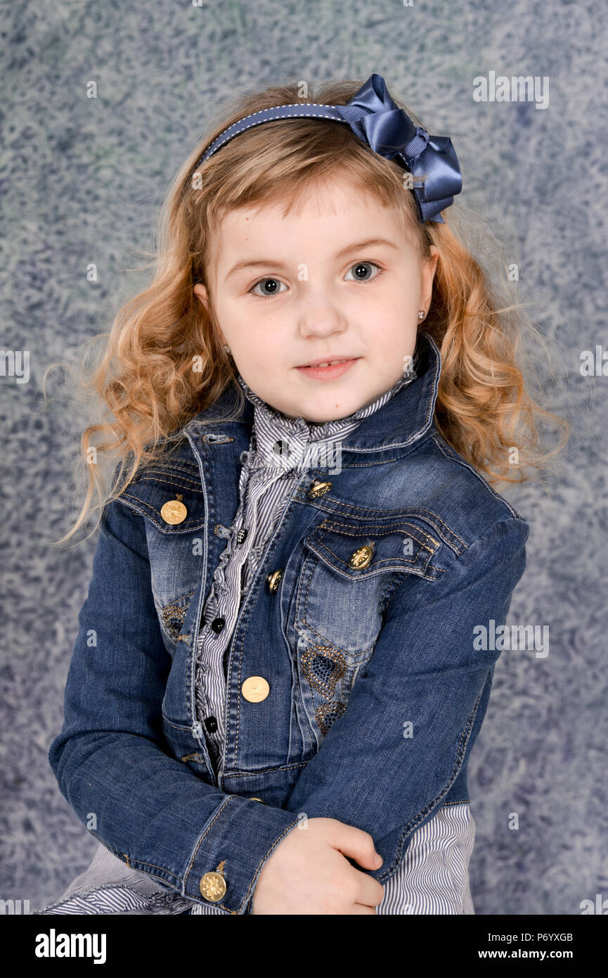 cute little girl in jeans jacket posing Stock Photo - Alamy