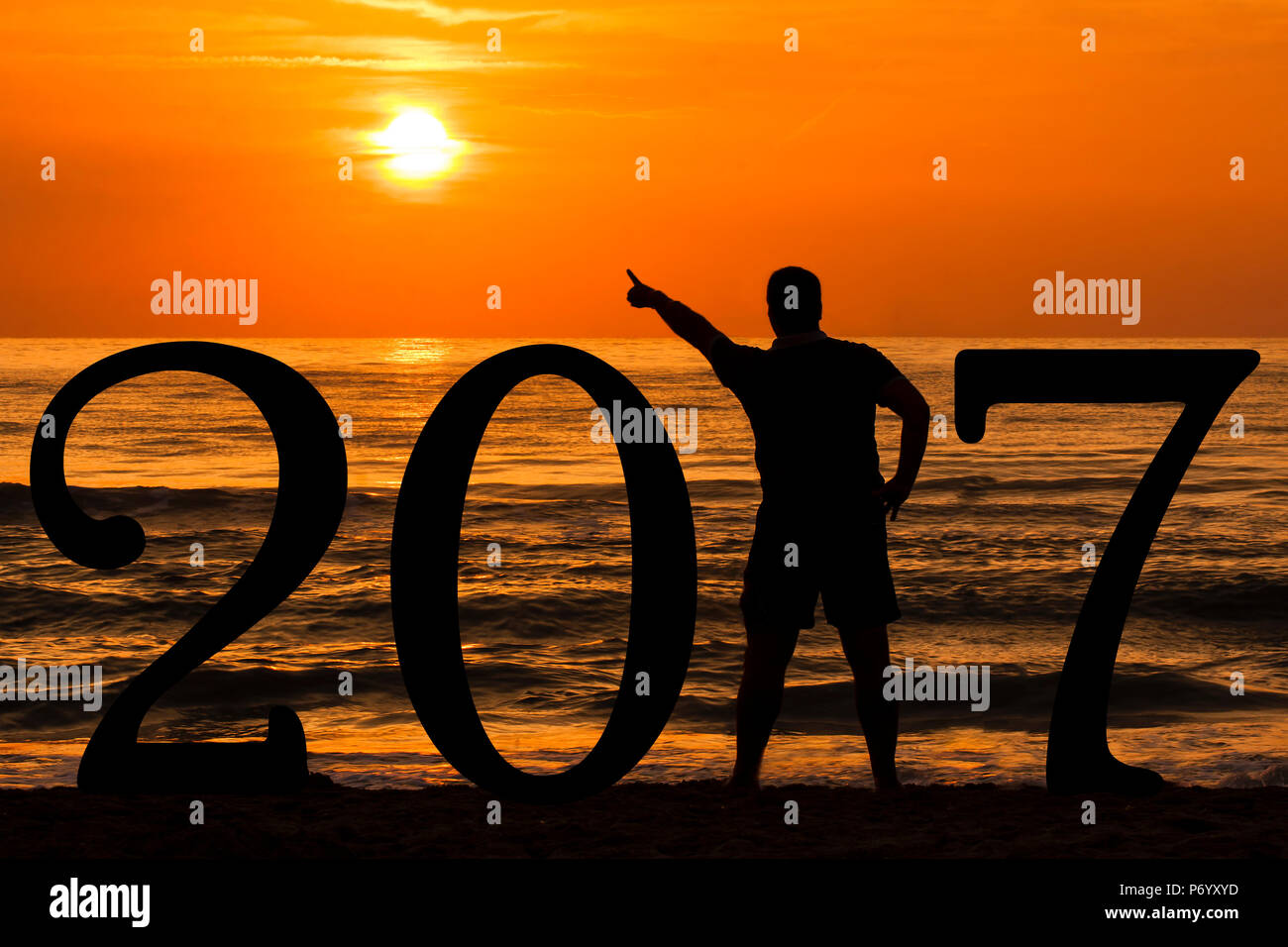 Man Silhouette year 2017 at sunrise at sea Stock Photo