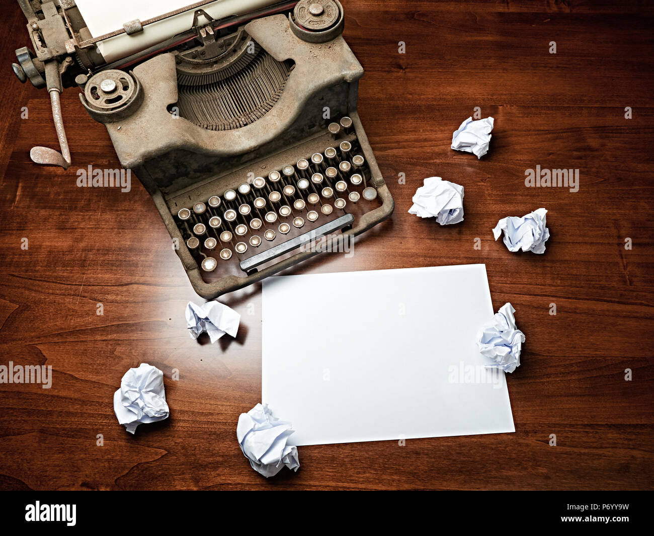 Vintage Typewriter covered with dust on desk and blank white sheet copy space Stock Photo