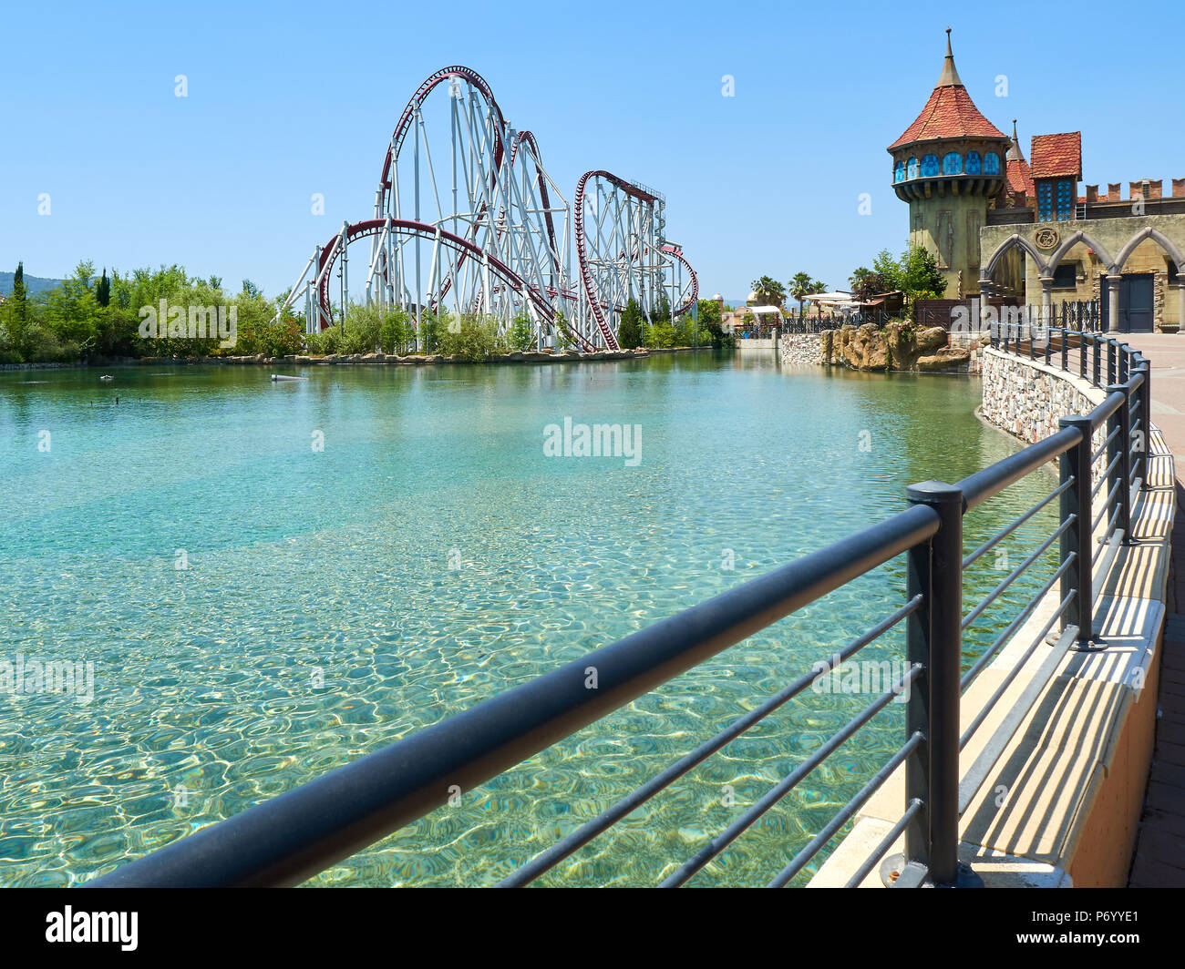 Roller coaster at funfair next to lake Stock Photo - Alamy
