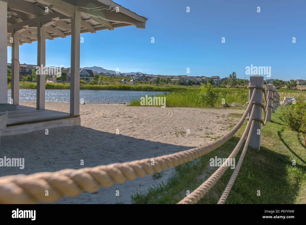 Lakeside ropes dividing the sand and landscaping Stock Photo - Alamy