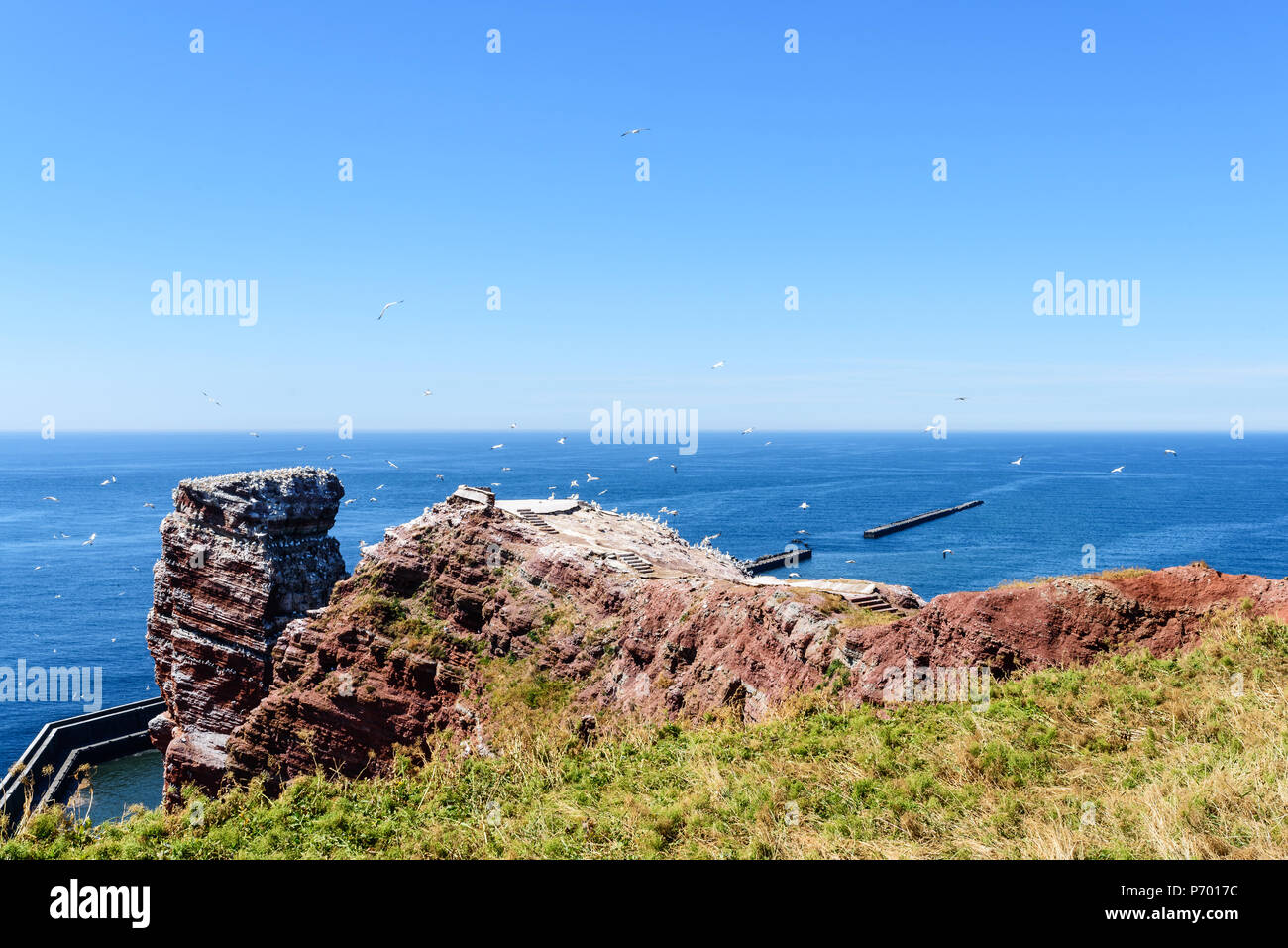 Lange Anna sea stack rock on Helgoland island against blue sea on clear day Stock Photo